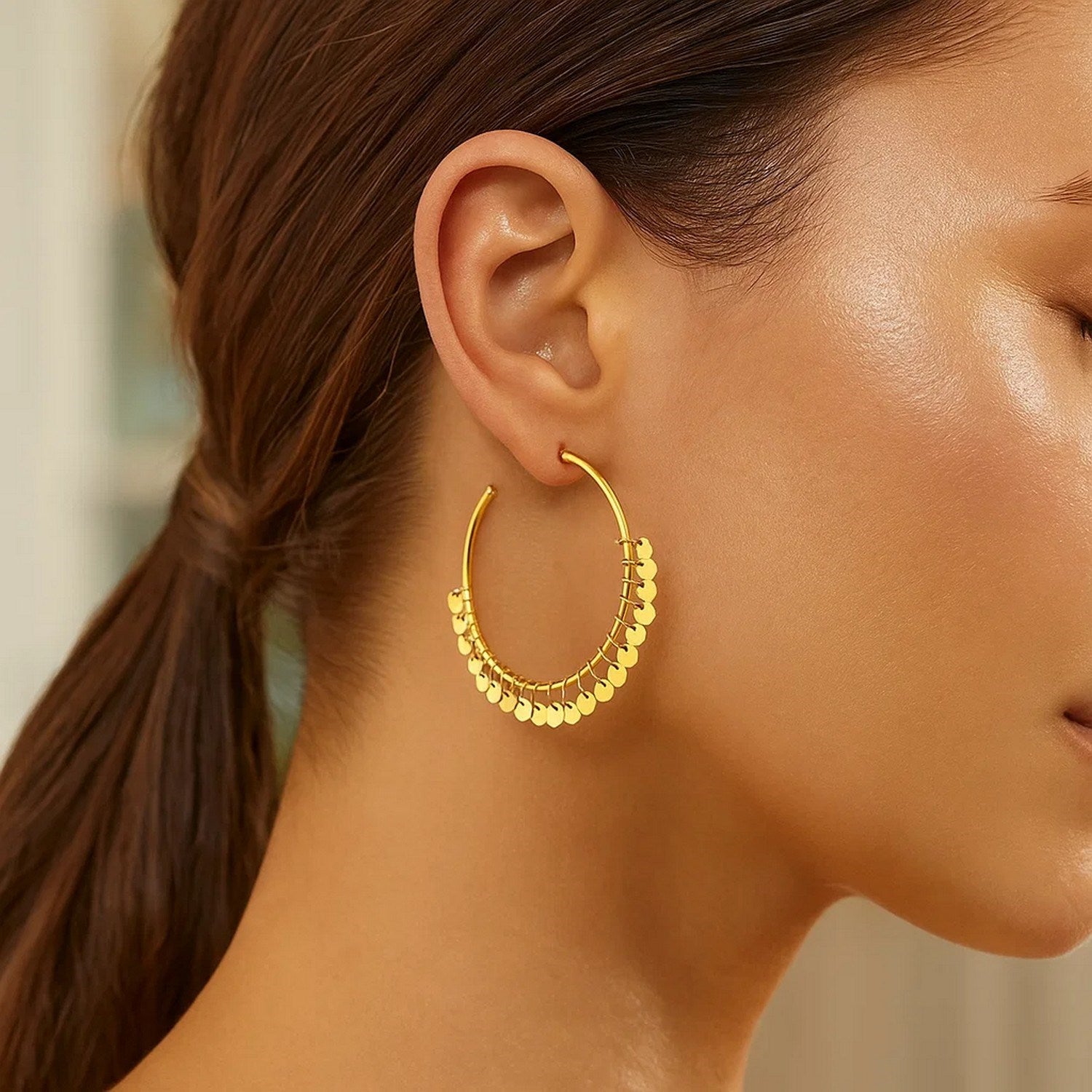 14k yellow gold modern hoop earrings adorned with elegant dangling sequins for a luxurious touch.