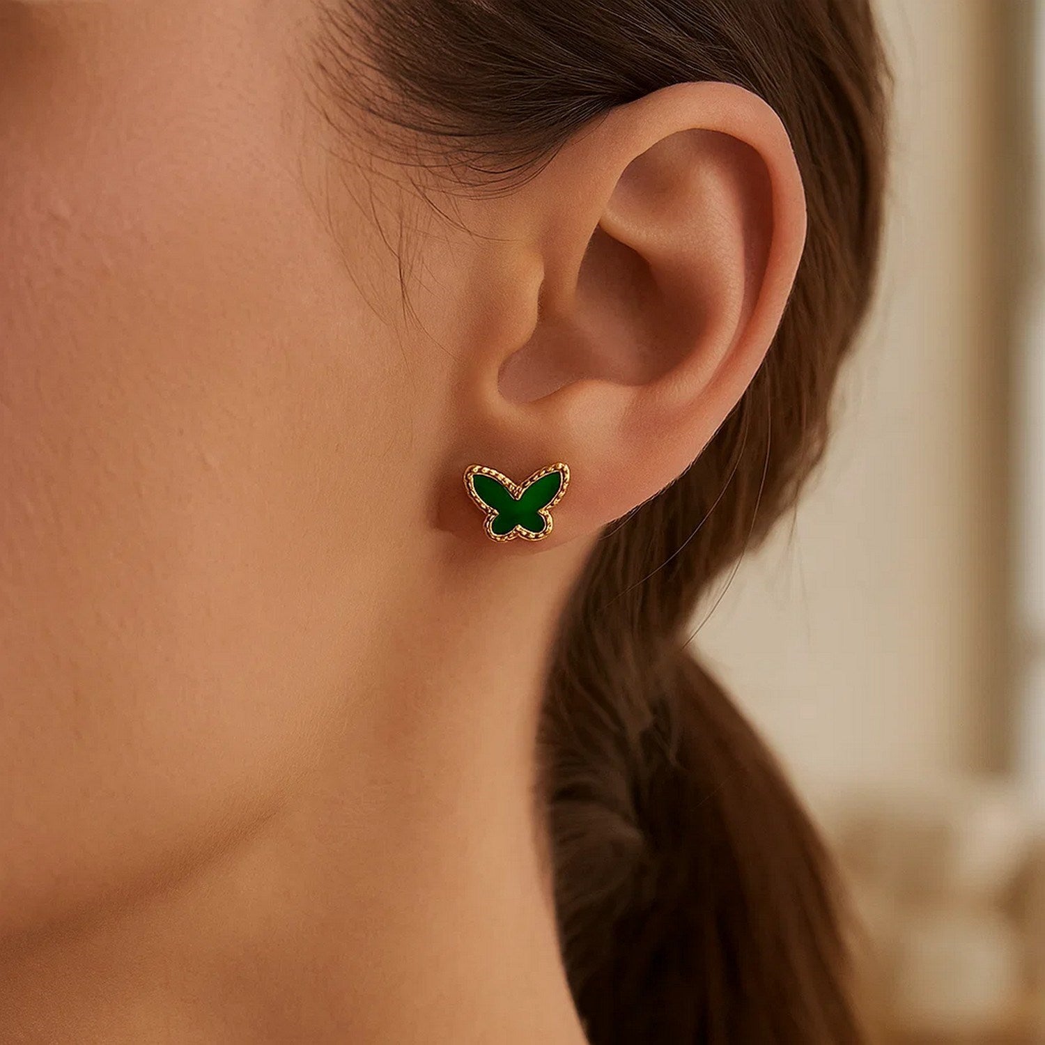14k yellow gold butterfly stud earrings featuring vibrant malachite accents in a modern design.