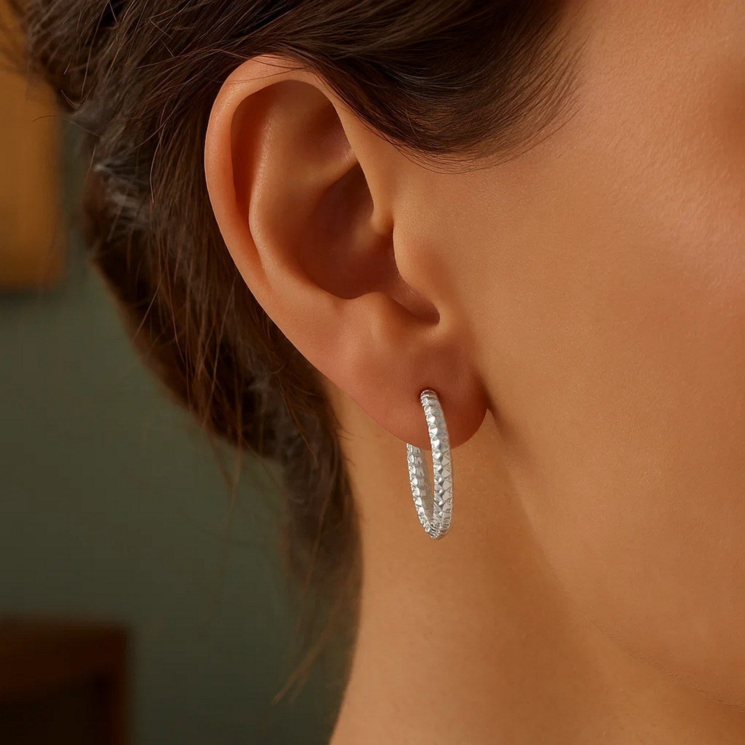Sterling silver large hoop earrings with intricate braid texture, showcasing modern elegance and timeless style.