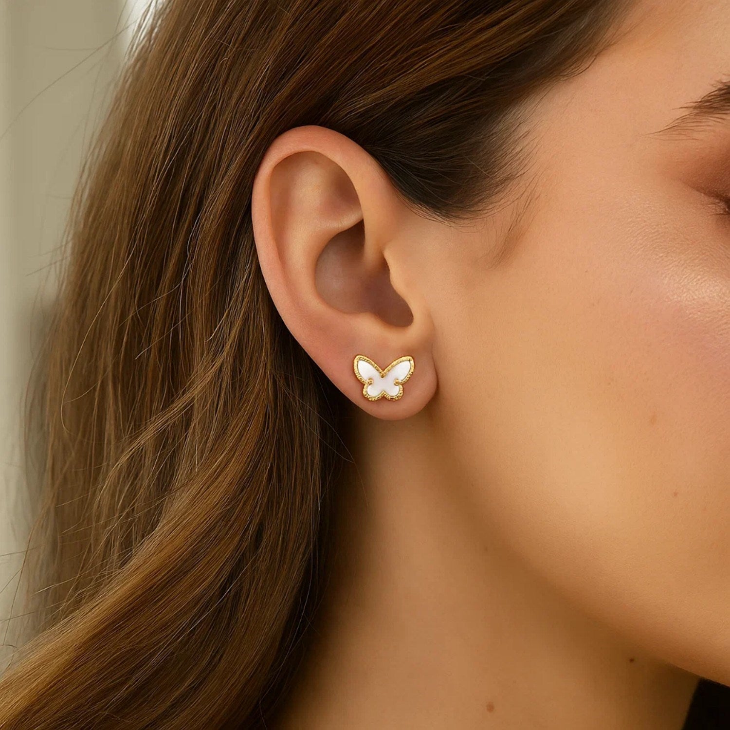 14k yellow gold stud earrings featuring elegant mother of pearl butterfly design, perfect for sophisticated occasions.