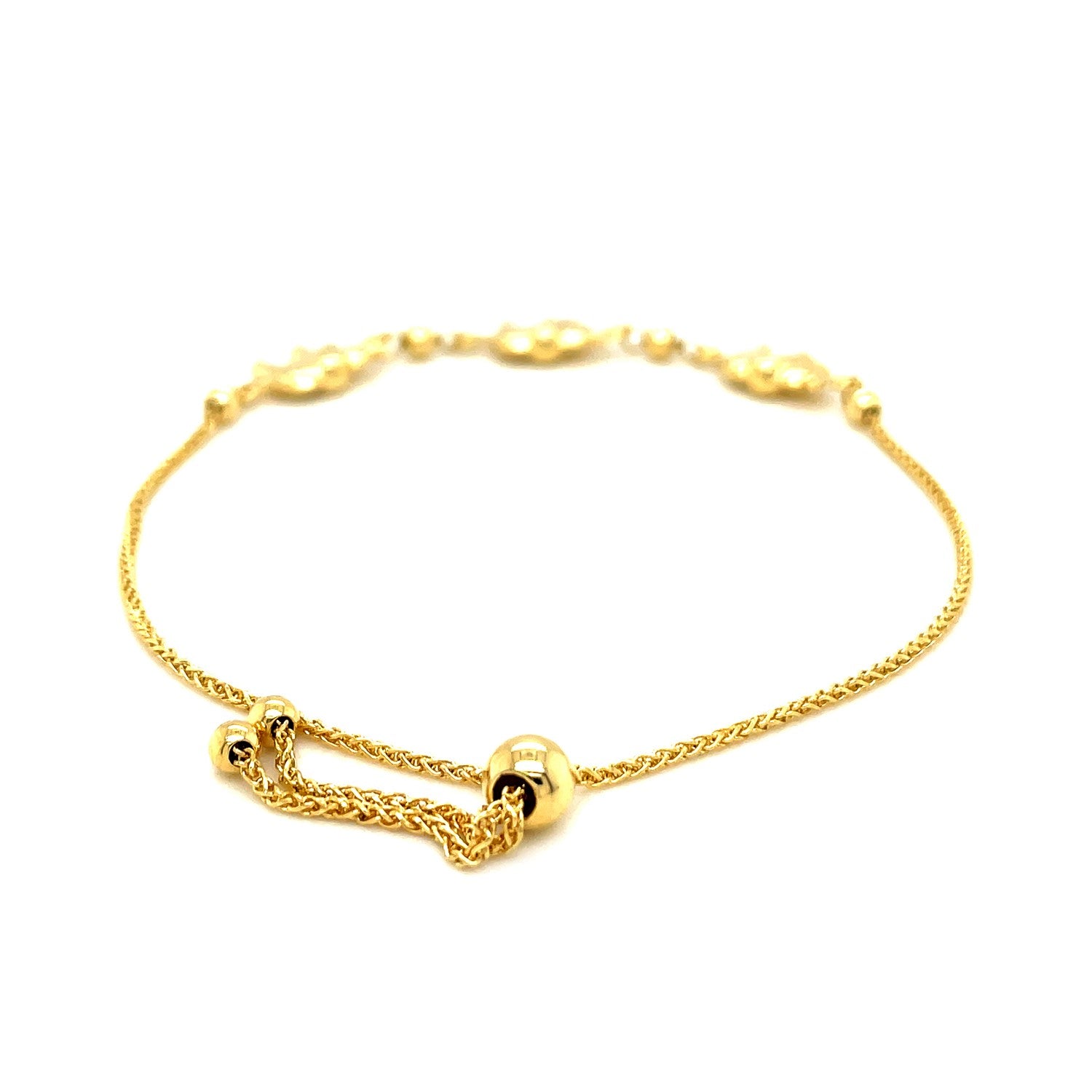 Elegant 14k yellow gold lariat bracelet featuring delicate elephant stations on a refined chain design.