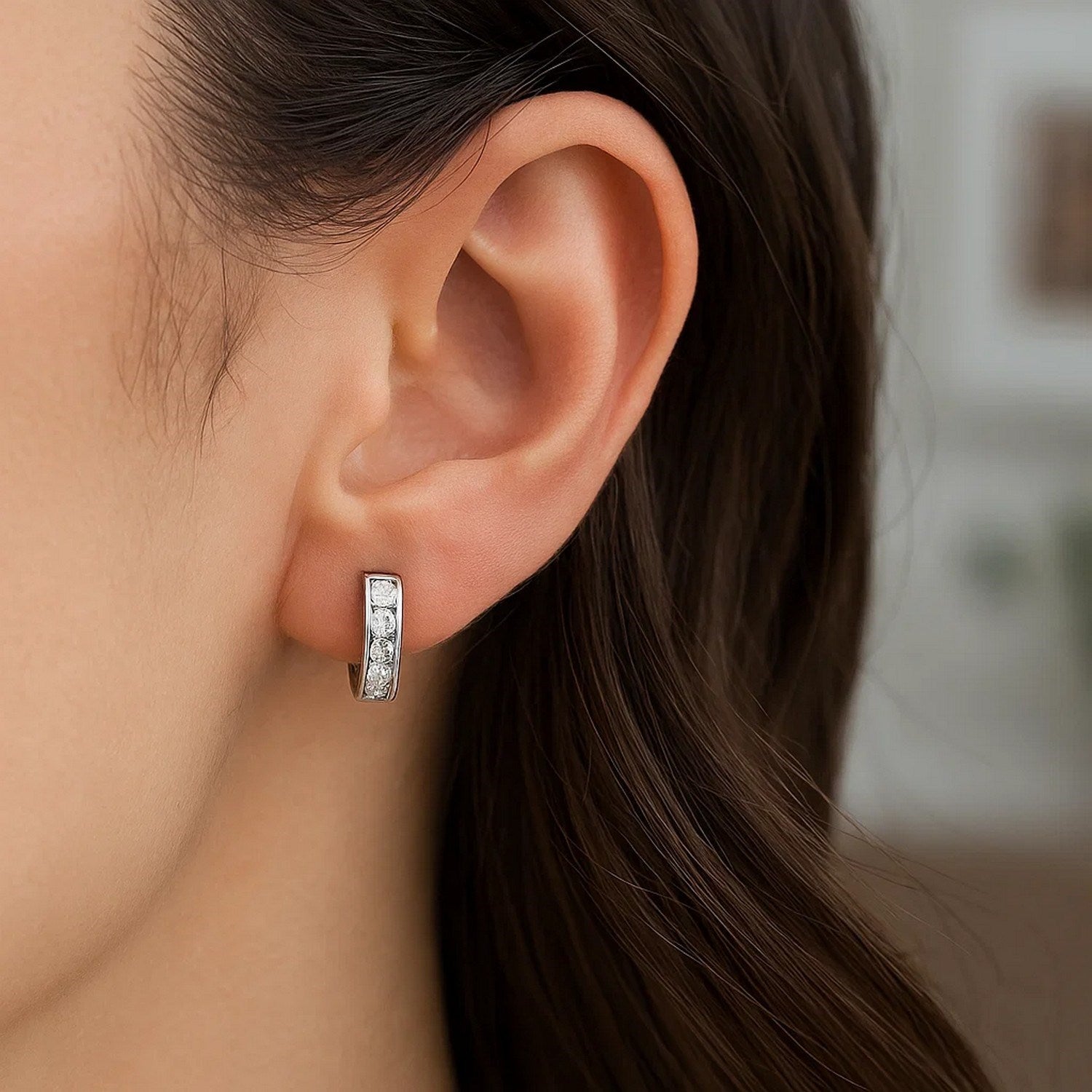 Sterling silver petite hoop earrings adorned with sparkling cubic zirconias, showcasing modern elegance and timeless style.