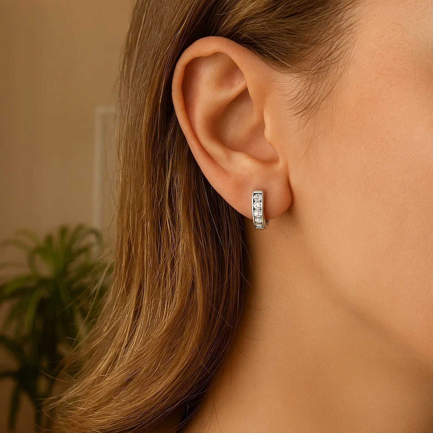 Sterling silver petite hoop earrings adorned with sparkling cubic zirconias, showcasing modern elegance and refined style.