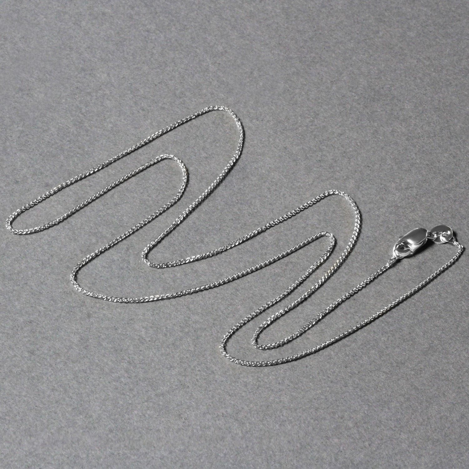 Elegant 14k white gold round wheat chain, 0.80 mm, showcasing a refined, timeless design for luxury jewelry lovers.