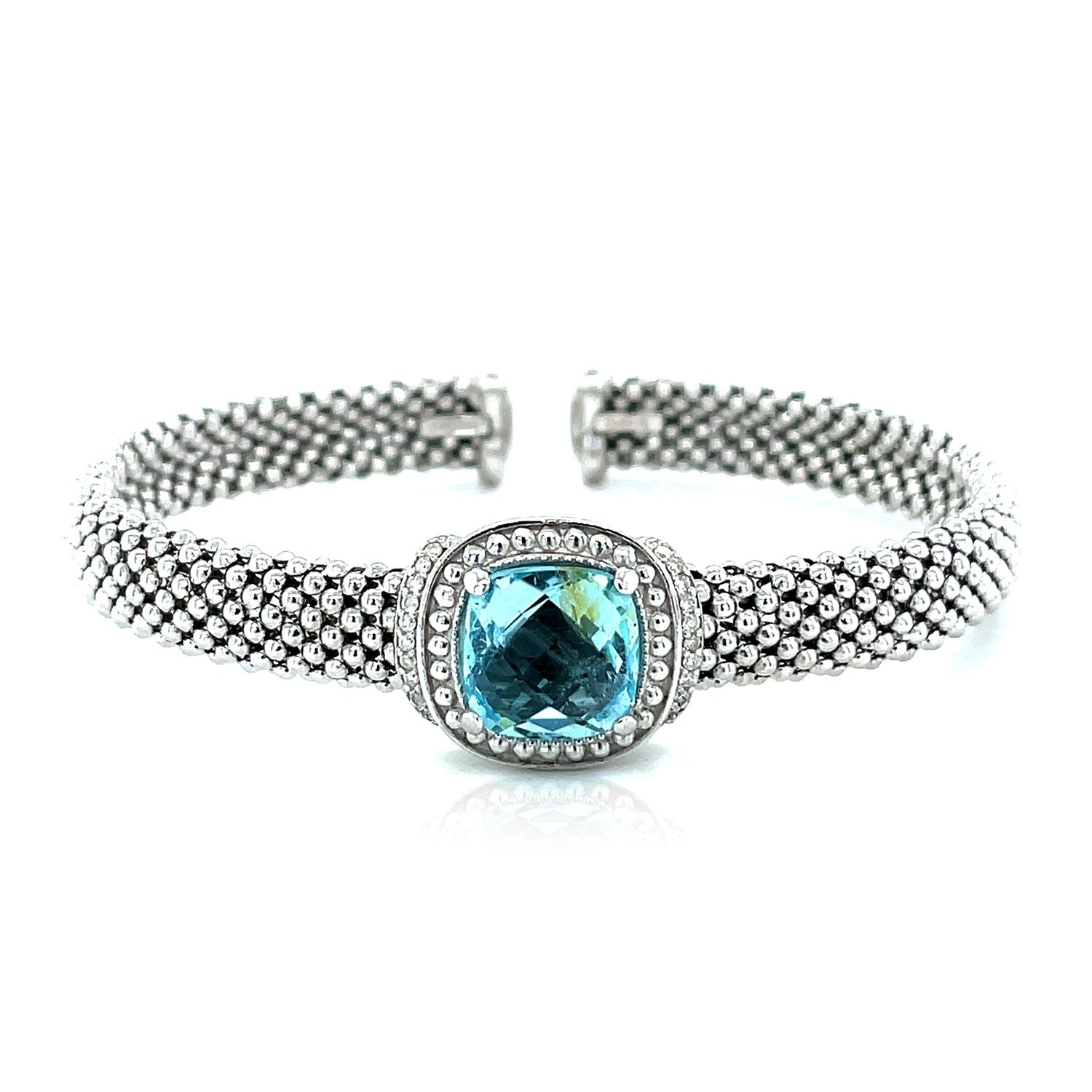 Sterling silver popcorn texture cuff bangle featuring prong-set blue topaz and diamonds for a modern elegance.