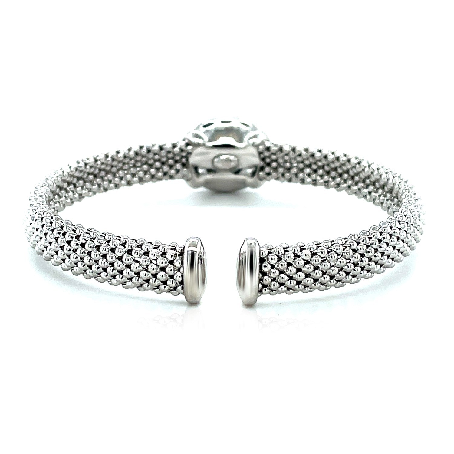 Sterling silver cuff bangle with popcorn texture, featuring prong-set blue topaz and diamonds for a modern elegance.