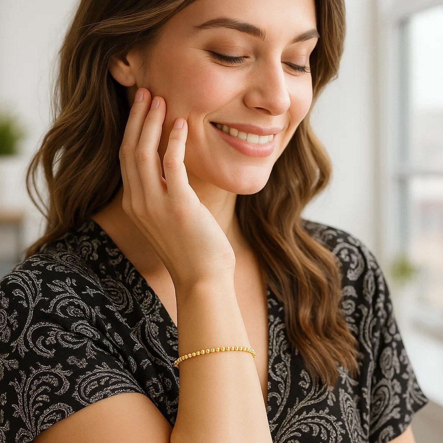 Elegant 14k yellow gold stretch bracelet featuring moon cut beads and diamond accents for a luxurious touch.