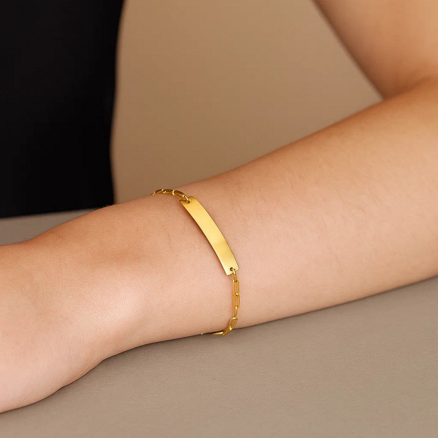14k yellow gold modern paperclip chain bracelet featuring a sleek bar design, perfect for elegant layering.
