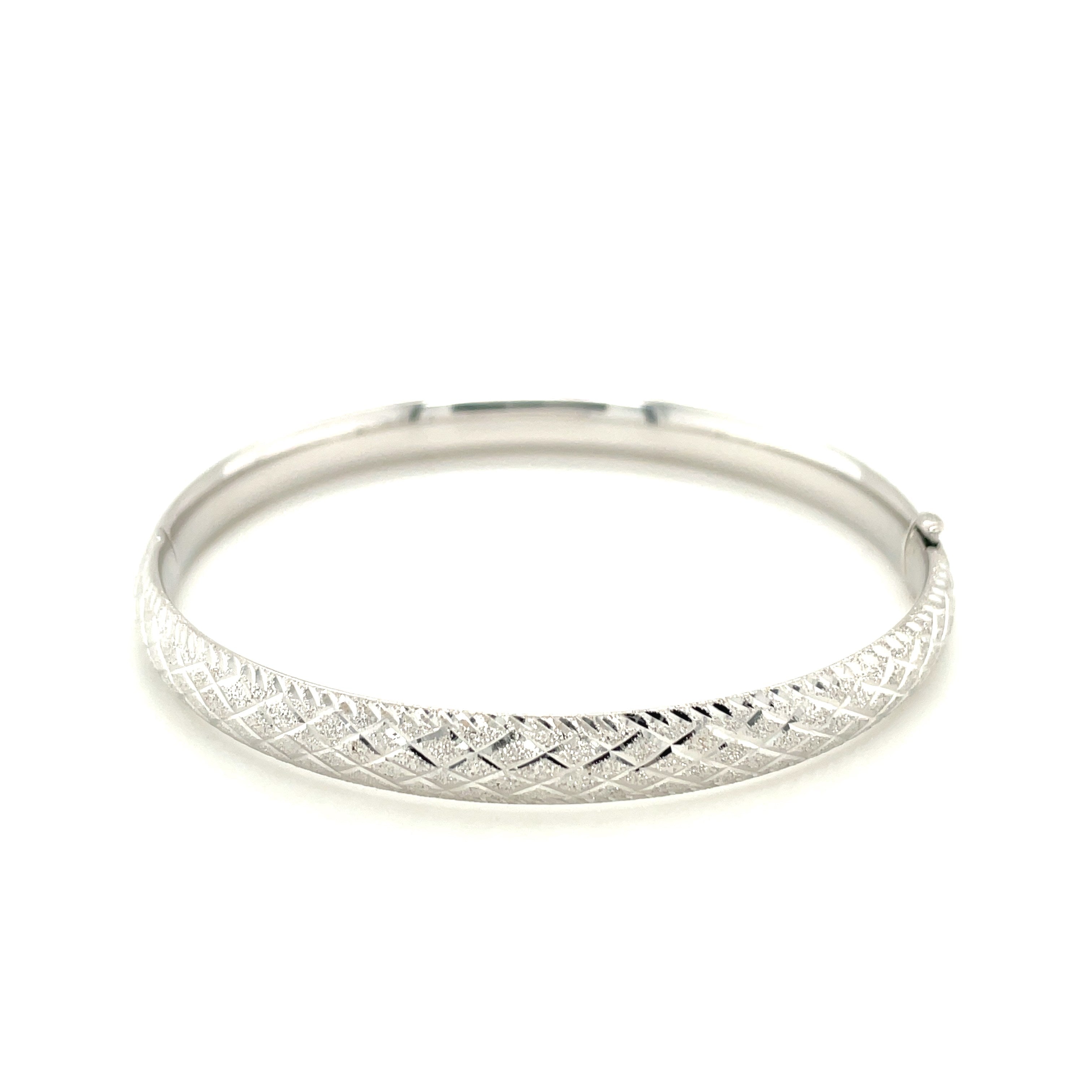 Elegant 14k white gold diamond carved bangle showcasing intricate design and luxurious craftsmanship.