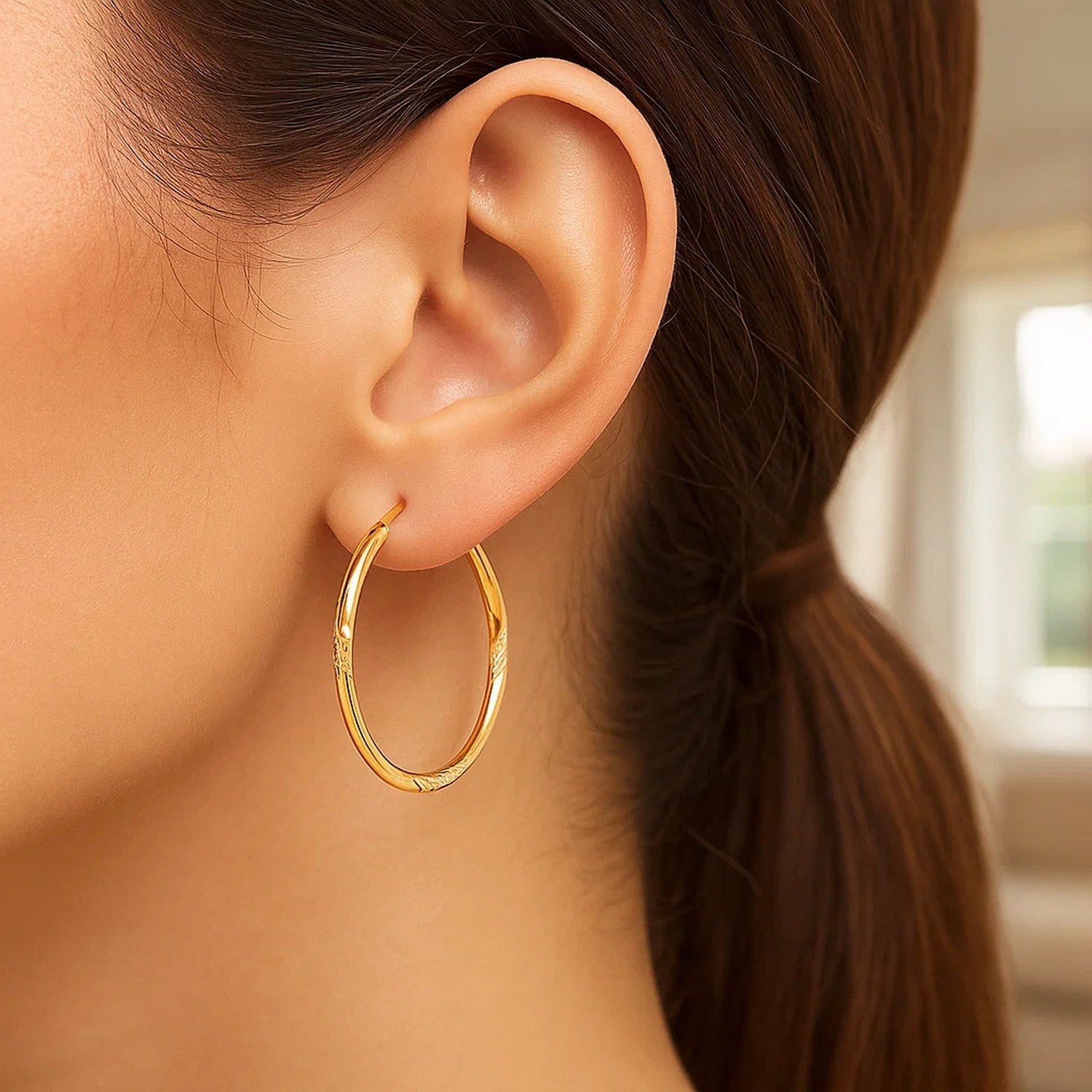 14k yellow gold diamond cut large hoop earrings with a modern design, showcasing exquisite craftsmanship and elegance.