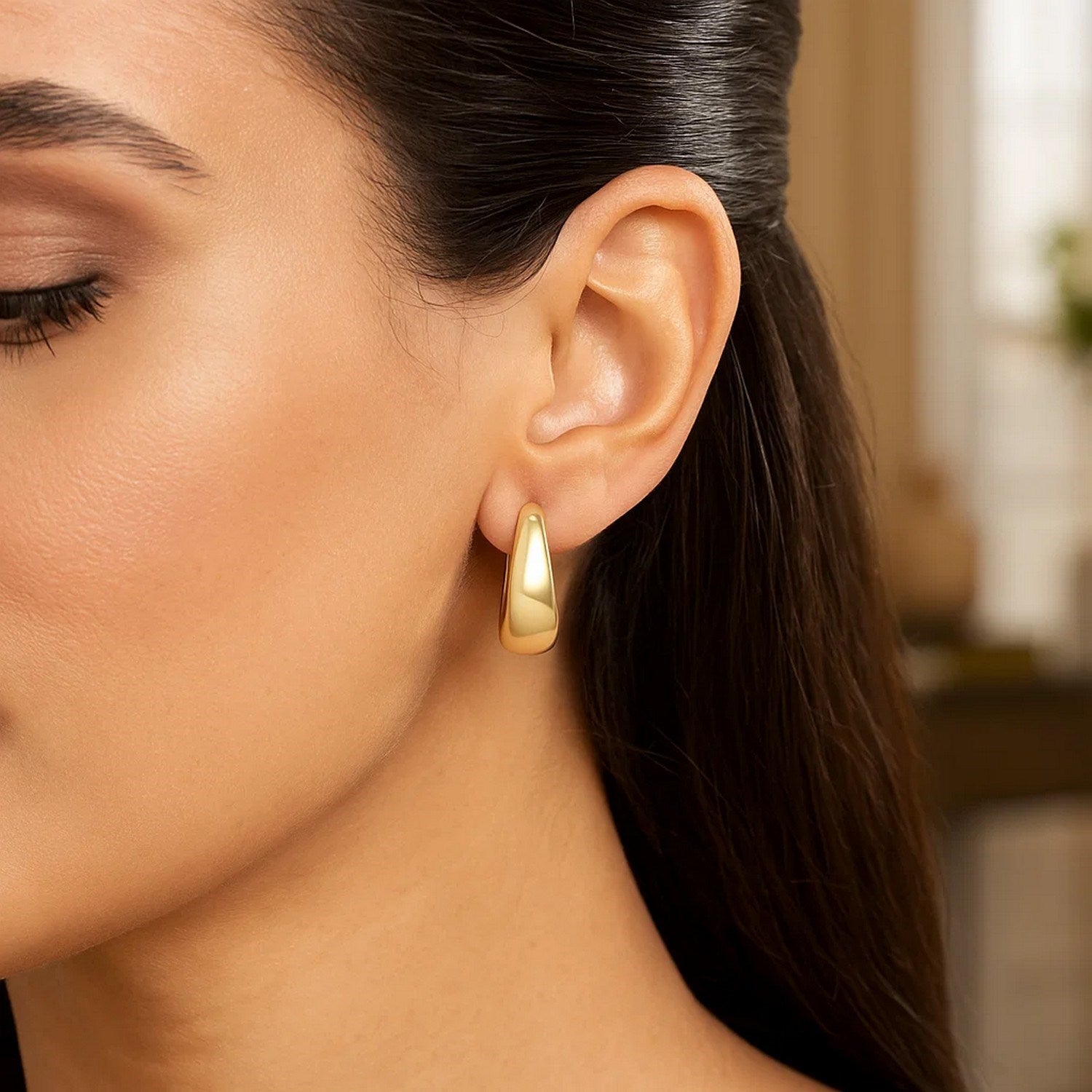14k yellow gold large tapered hoop earrings with a sleek modern design, perfect for elegant everyday wear.