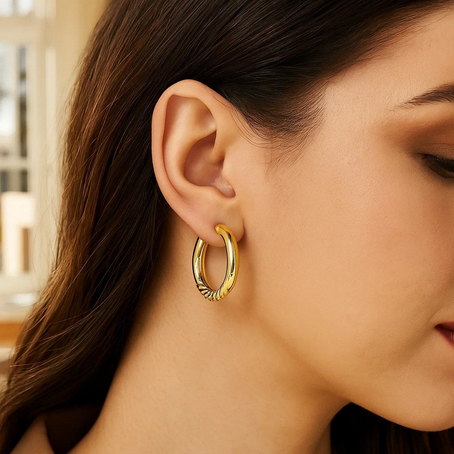 Polished 14k yellow gold large hoop earrings with modern design, perfect for elegant occasions.