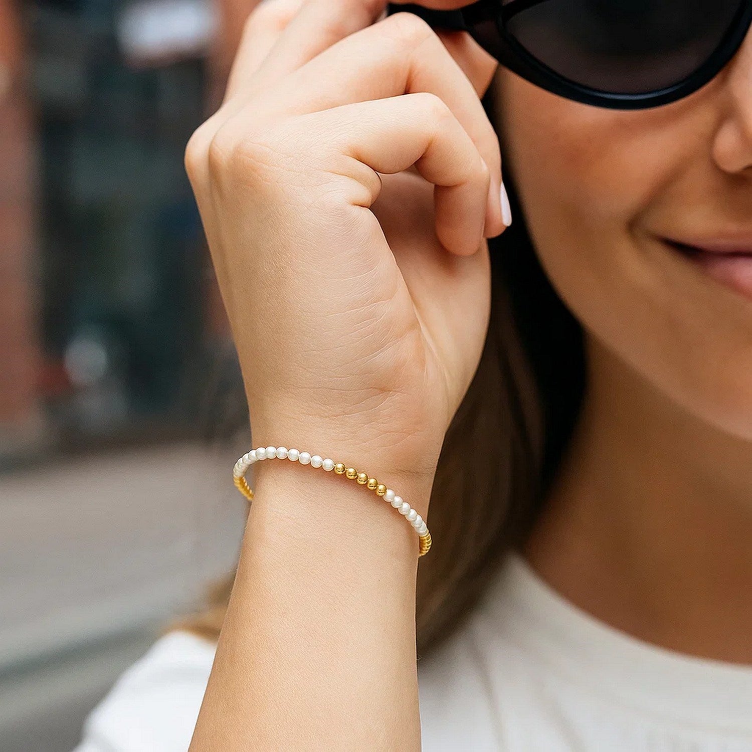 Elegant 14k yellow gold bracelet featuring high polish freshwater pearls and a refined pallina bead design.