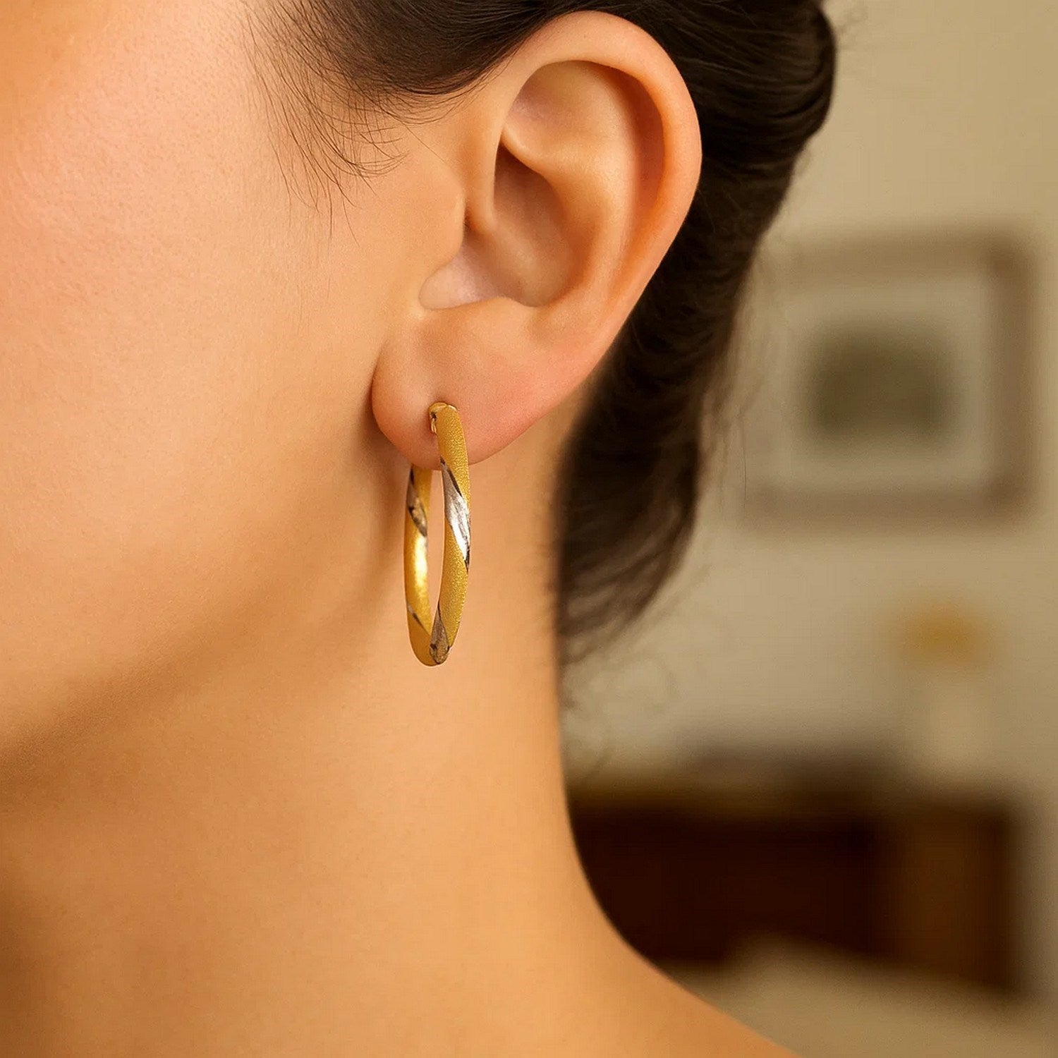 14k two-tone gold polished hoop earrings showcasing a modern design with a sleek, luxurious finish.