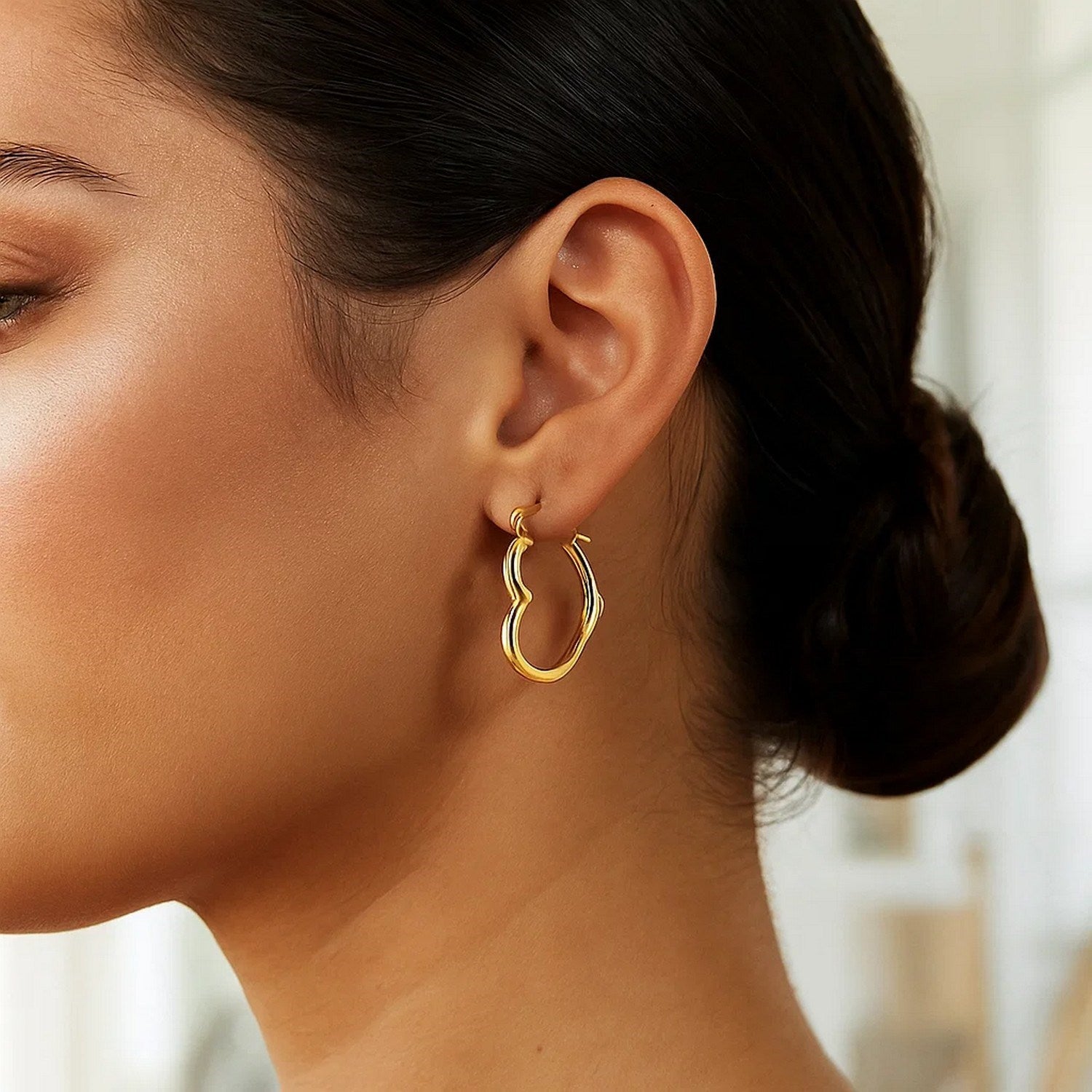 Contemporary 10k yellow gold heart hoop earrings, crafted in 14k gold for a luxurious touch.