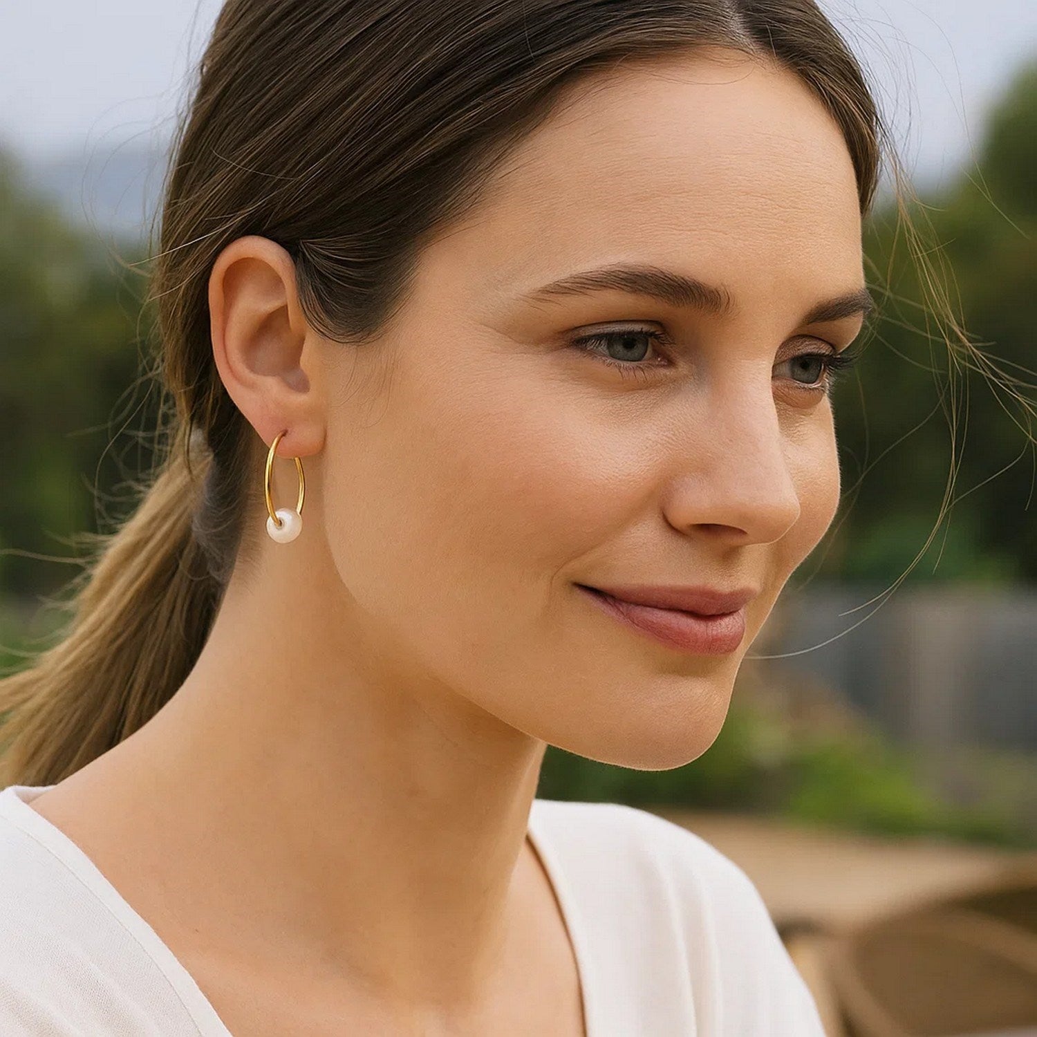 14k yellow gold modern pearl hoop earrings featuring elegant round design and luxurious finish.