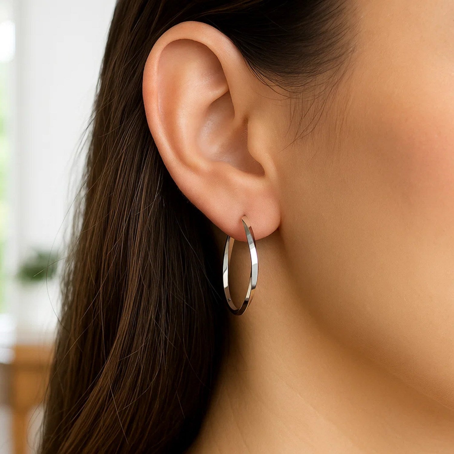 14k white gold Mobius twisted hoop earrings with a sleek modern design, perfect for elegant occasions.