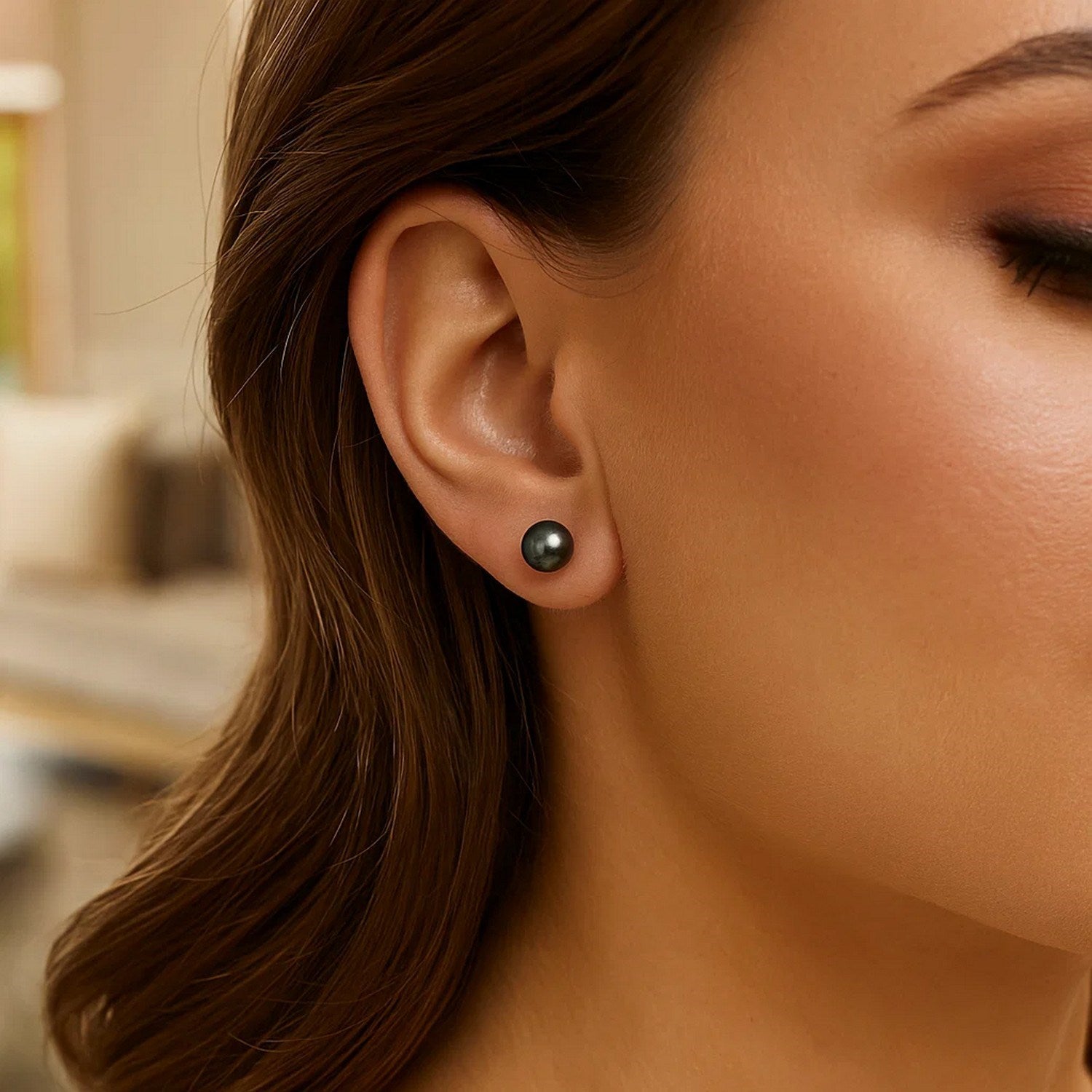 14k yellow gold stud earrings featuring 7mm cultured black pearls in a modern round design.
