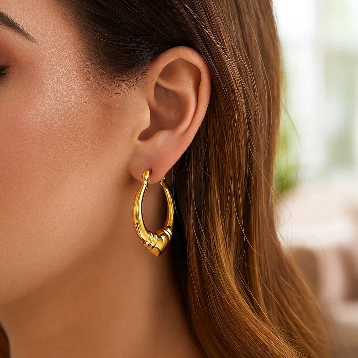 14k yellow gold polished heart hoop earrings with a modern design, perfect for elegant everyday wear.