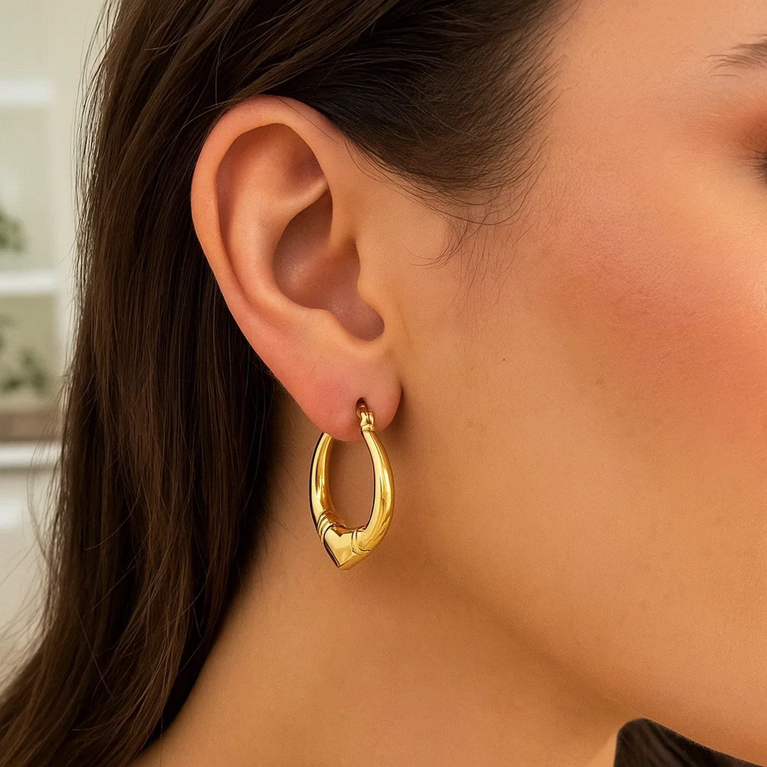 14k yellow gold polished heart hoop earrings with a modern design, perfect for elegant everyday wear.