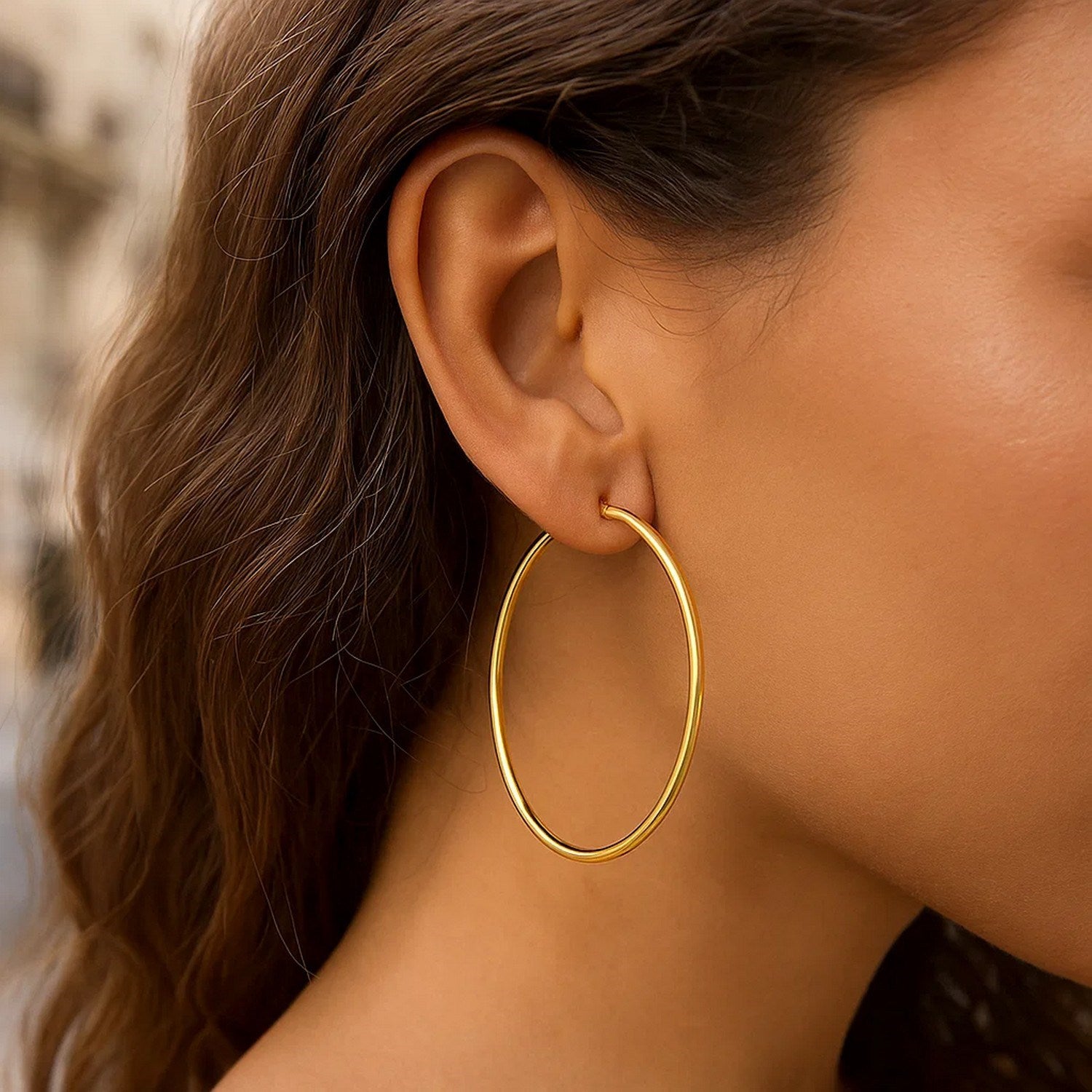 14k yellow gold polished hoop earrings, modern design, 55mm diameter, perfect for elegant everyday wear.