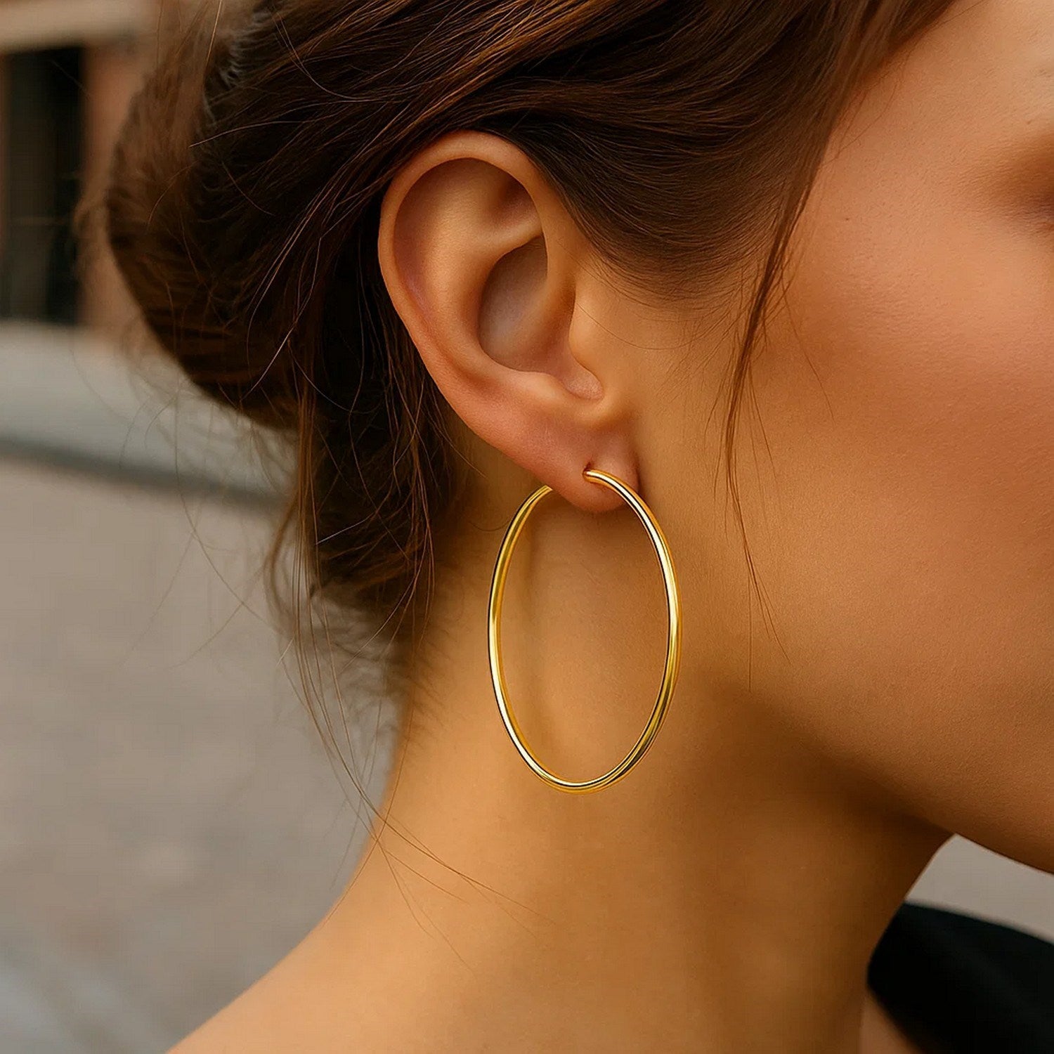 14k yellow gold polished hoop earrings, modern design, 55mm diameter, perfect for elegant everyday wear.