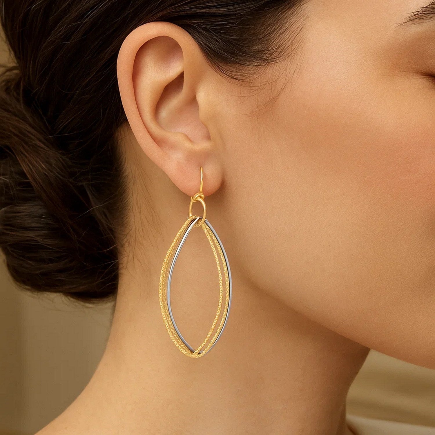 14k two-tone gold textured triple oval drop earrings showcasing contemporary elegance and luxurious craftsmanship.