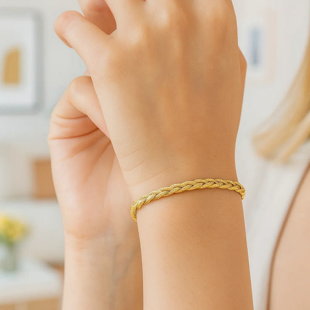 14k yellow gold braided bracelet with a modern design, showcasing luxury craftsmanship and elegance.