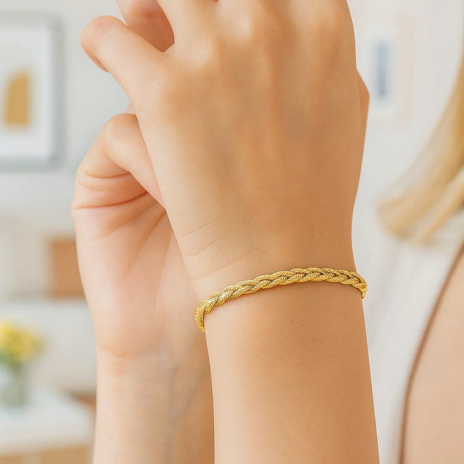 14k yellow gold braided bracelet with a modern design, showcasing luxury craftsmanship and elegance.