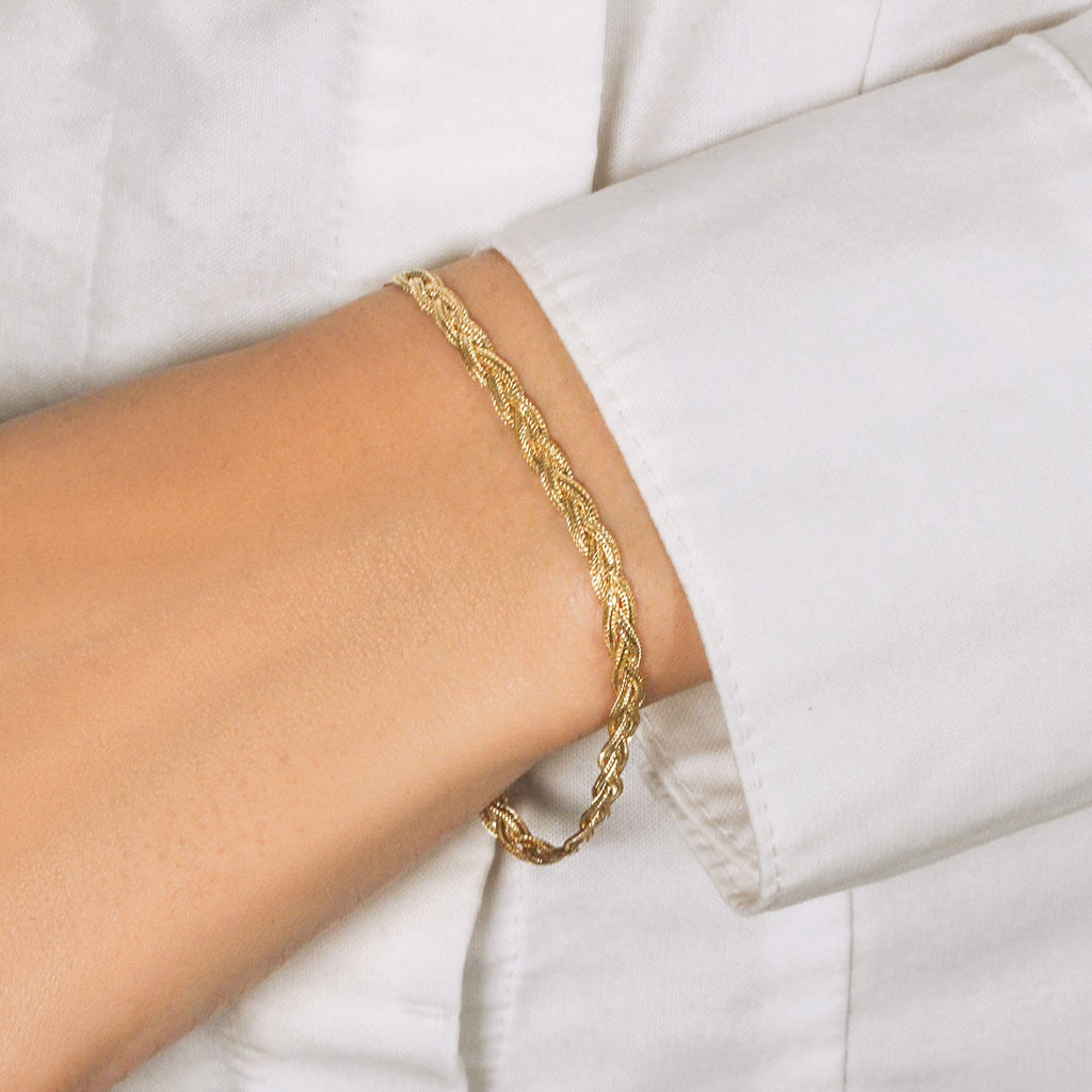 14k yellow gold braided bracelet with a modern design, showcasing luxury craftsmanship and elegance.