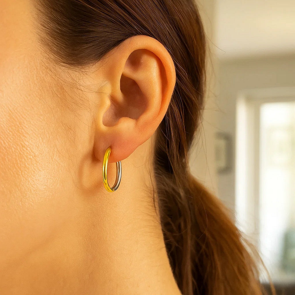 14k two-tone gold polished hoop earrings with a sleek minimalist design for timeless elegance.