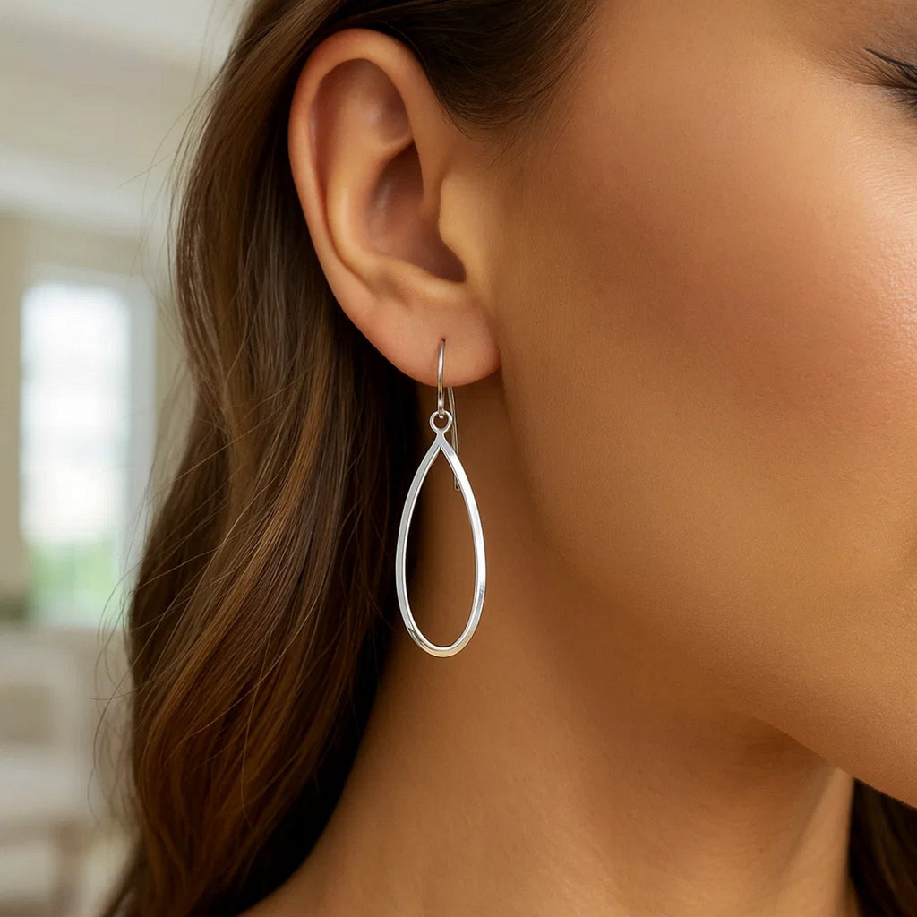 Polished 14k white gold dangle earrings featuring a modern drop design, perfect for elegant occasions.