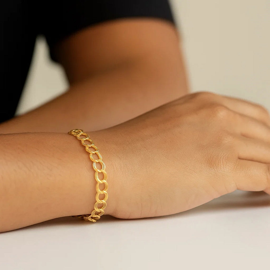 14k yellow gold triple link charm bracelet with modern design and elegant shine, perfect for luxury jewelry lovers.