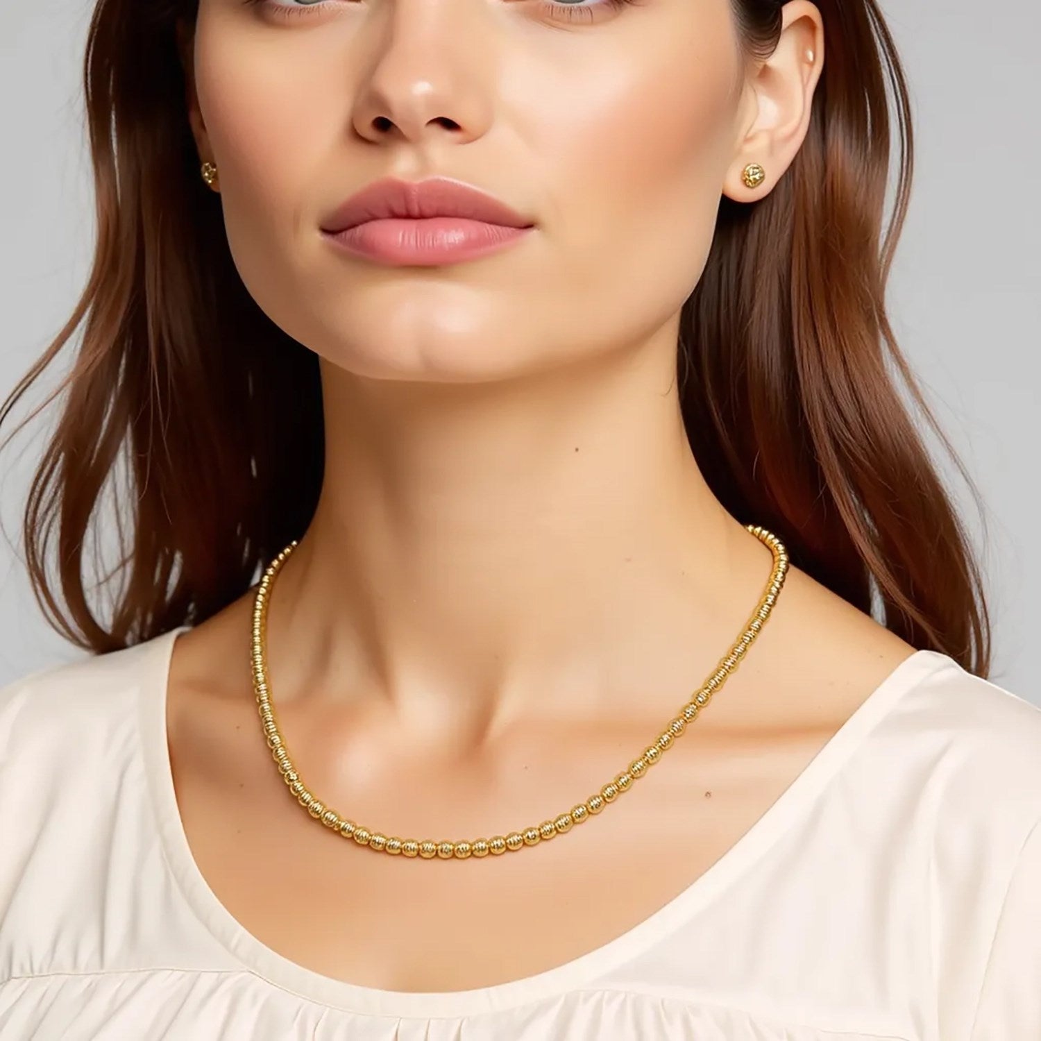 Graduated bead necklace in 14k yellow gold featuring exquisite diamonds, modern luxury design for elegant style.