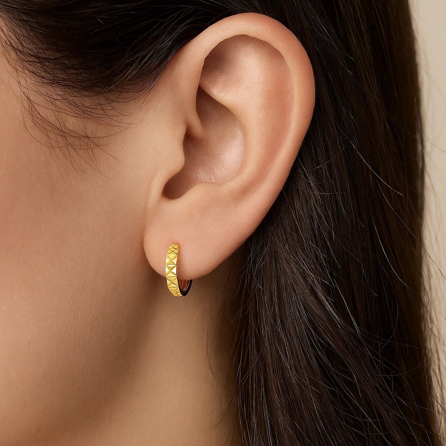 14k yellow gold geometric textured hoop earrings with a modern design, showcasing elegance and sophistication.