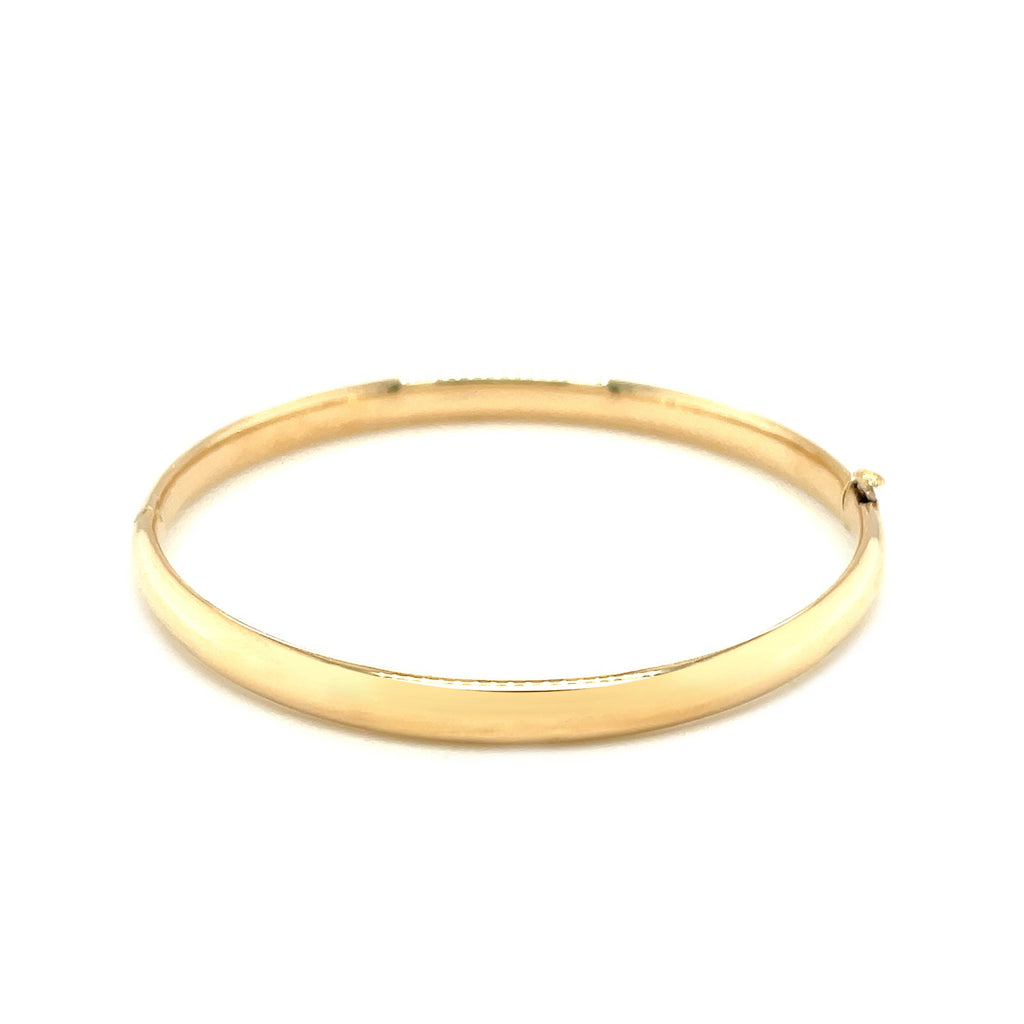 14k yellow gold polished children's bangle with elegant dome design, perfect for luxury gifting and special occasions.