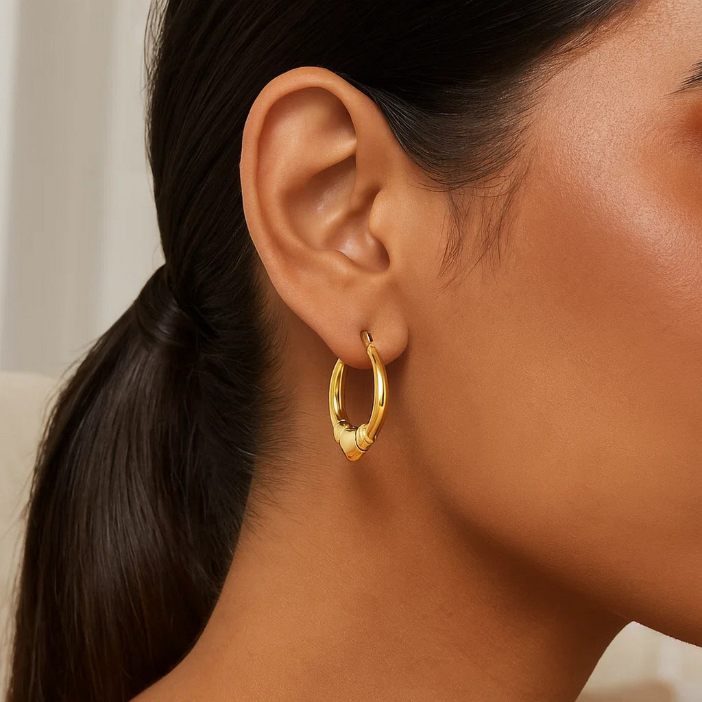 14K yellow gold polished heart hoop earrings with a modern design, perfect for elegant everyday wear.