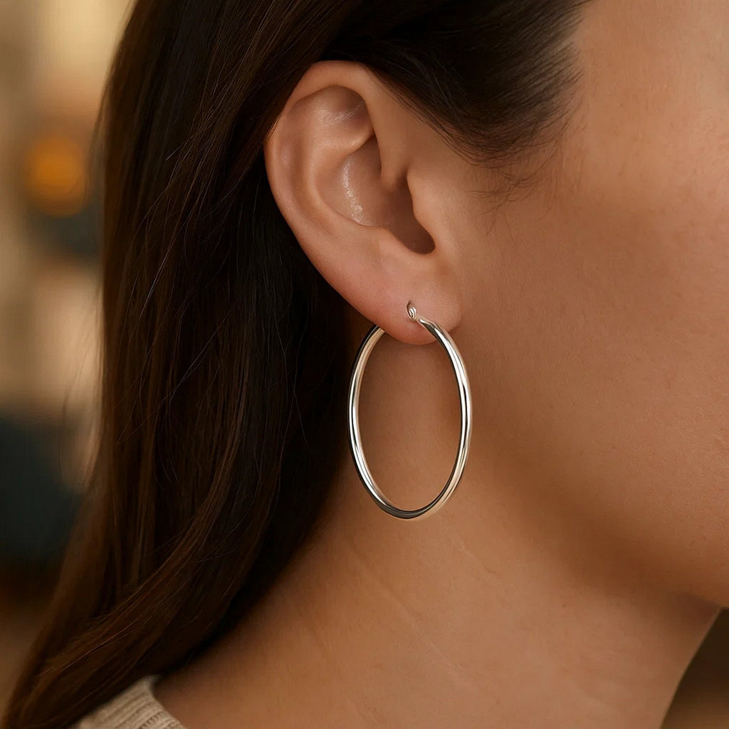 Polished 14k white gold hoop earrings with a modern design, showcasing elegance and timeless sophistication.