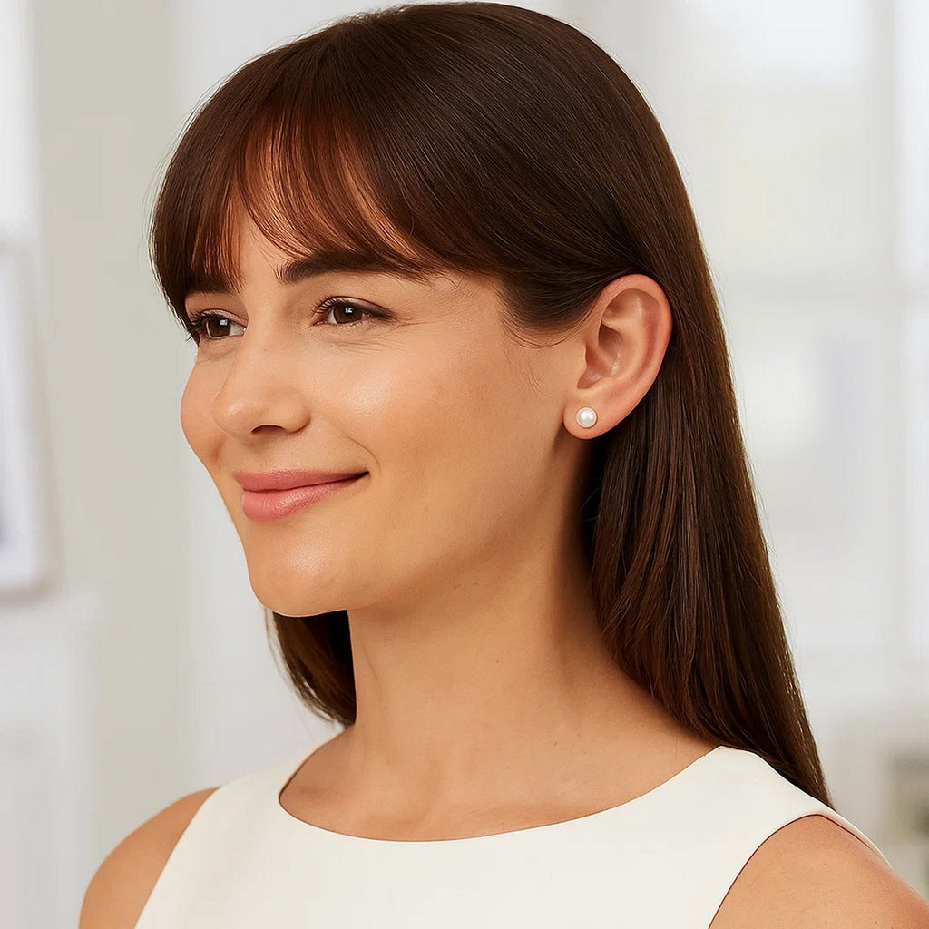 14k yellow gold stud earrings featuring 8mm round freshwater cultured pearls in a modern design.