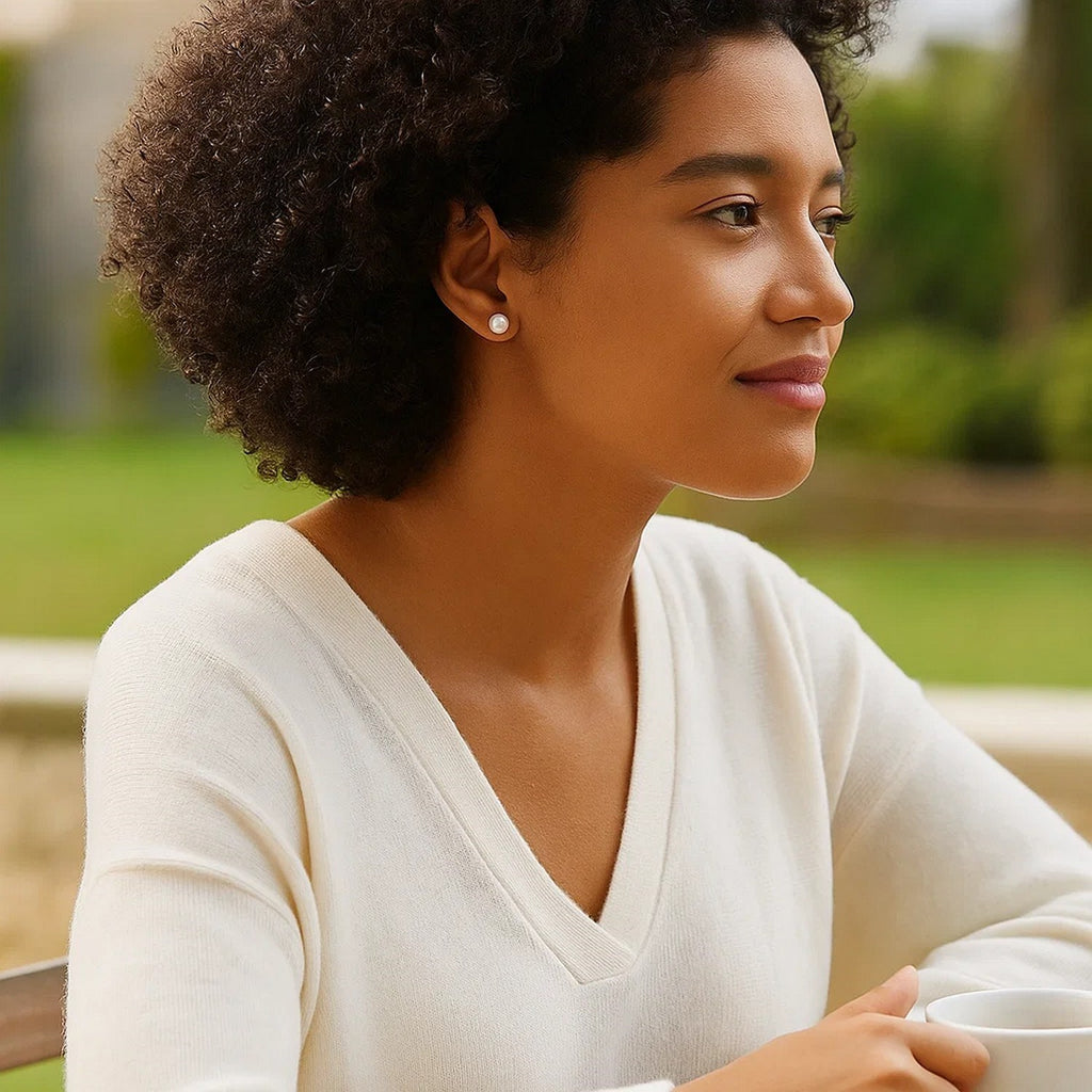 14k yellow gold stud earrings featuring 8mm round freshwater cultured pearls in a modern design.