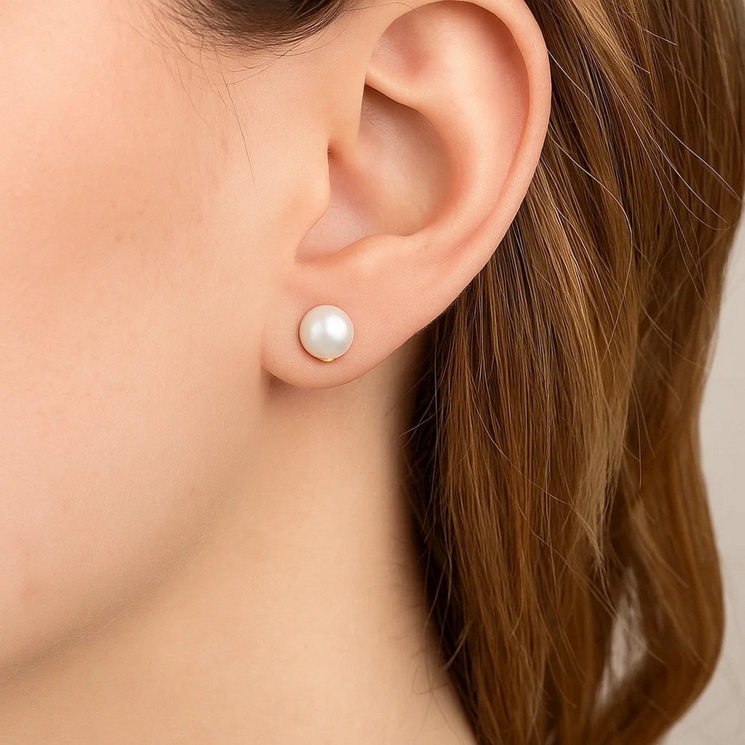 14k yellow gold stud earrings featuring 8mm round freshwater cultured pearls in a modern design.