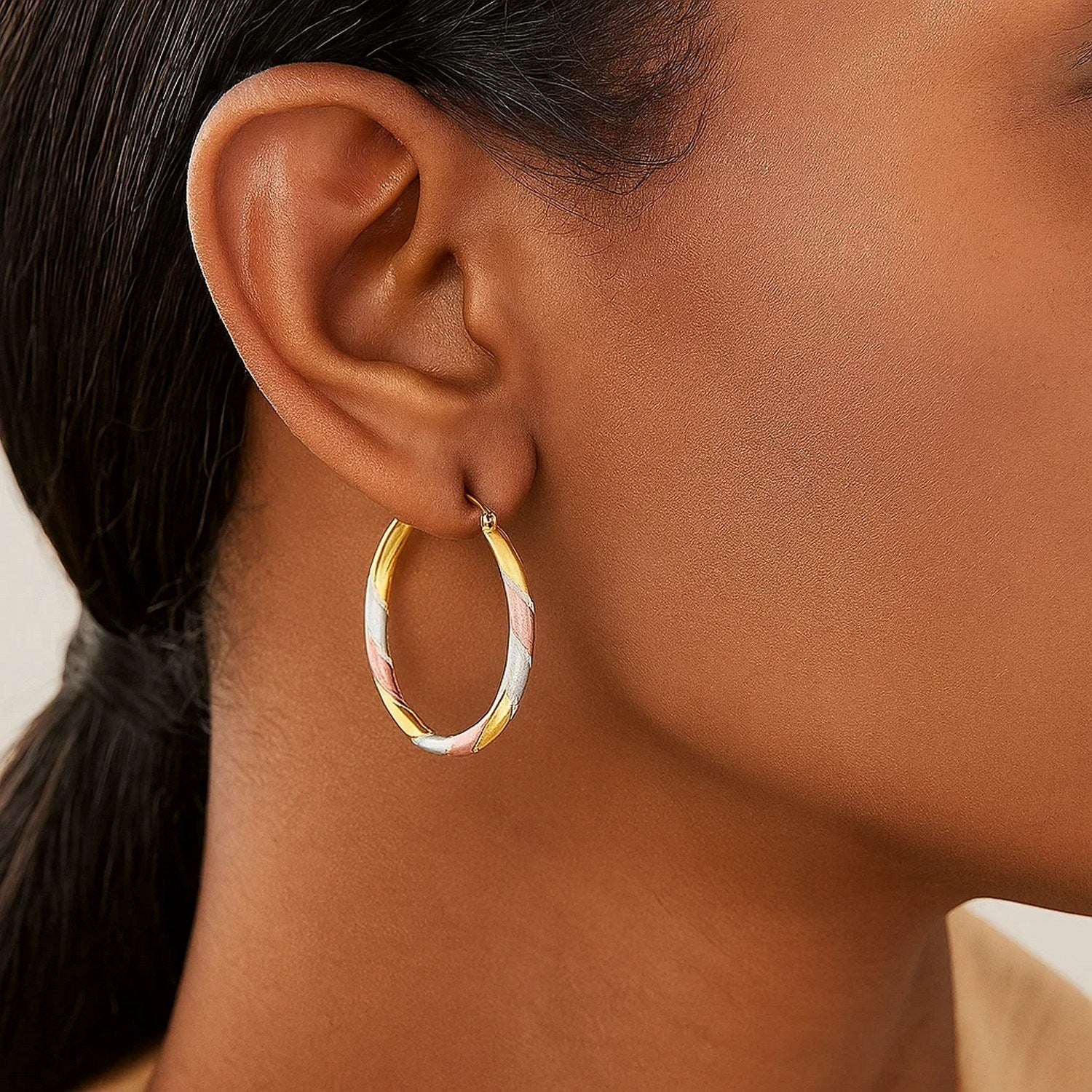 14k tri-color gold textured hoop earrings showcasing a minimalist design, perfect for elegant everyday wear.