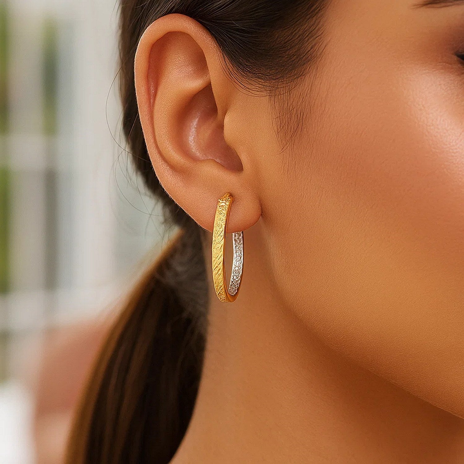 14k two-tone yellow and white gold textured hoop earrings, showcasing modern elegance and luxurious craftsmanship.