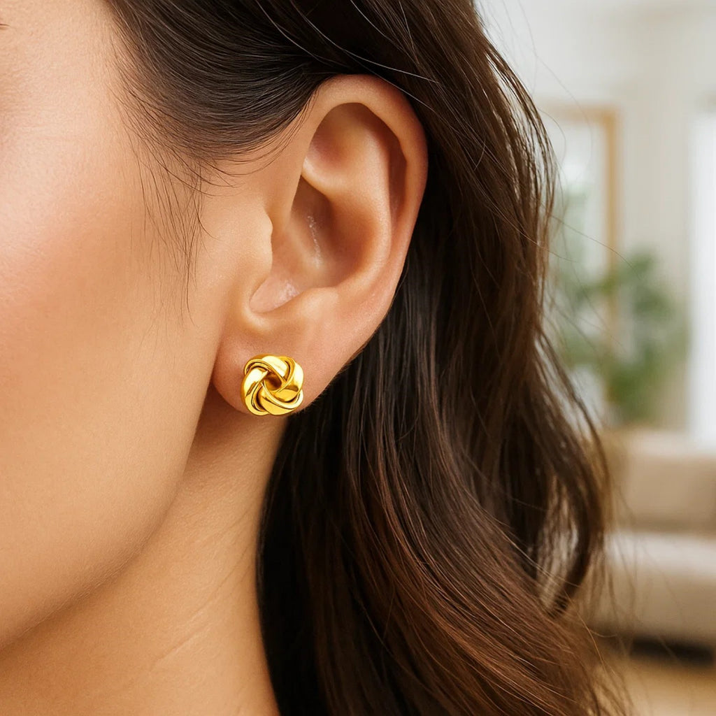 14k yellow gold classic love knot stud earrings showcasing timeless elegance and intricate design craftsmanship.