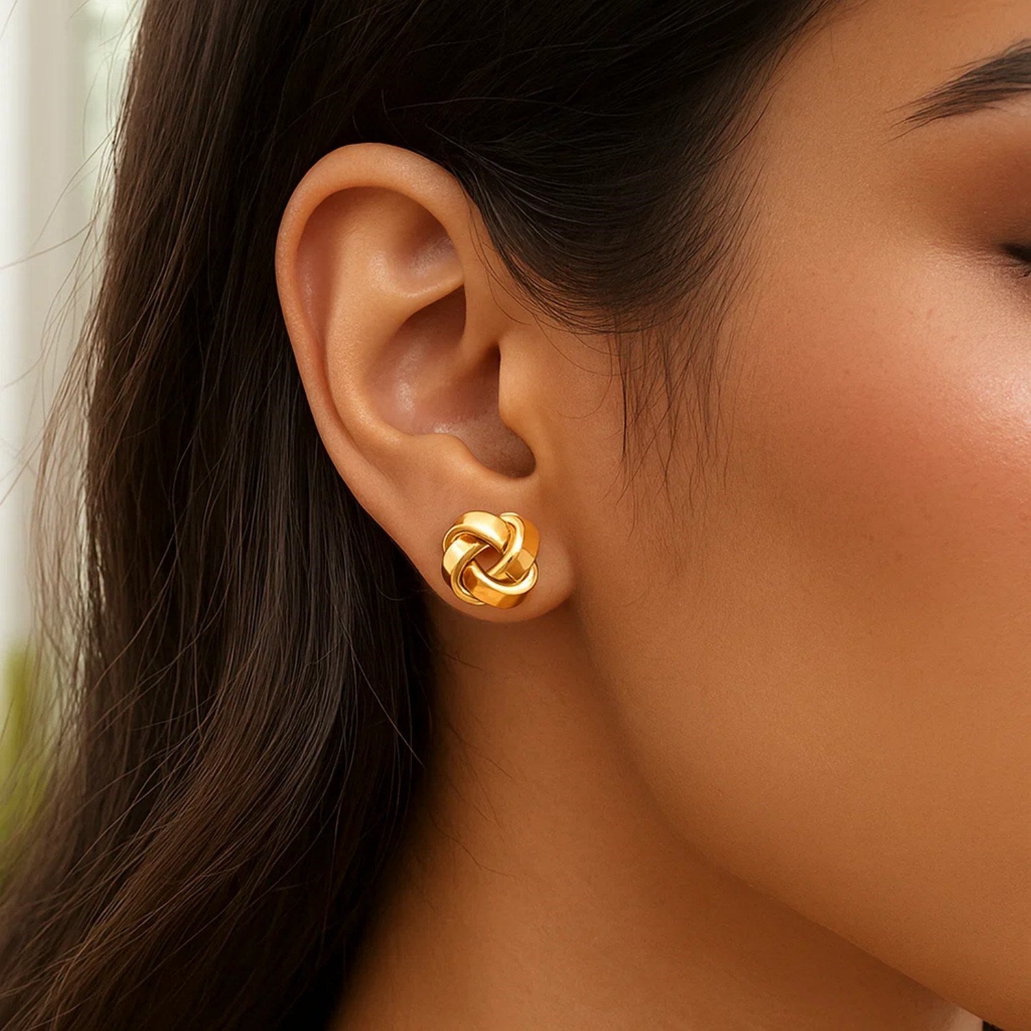 14k yellow gold classic love knot stud earrings showcasing timeless elegance and intricate design.