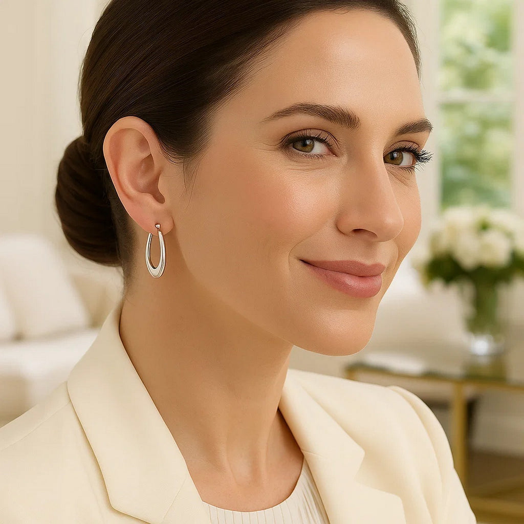 14k white gold polished graduated oval hoop earrings, showcasing modern elegance and timeless sophistication.