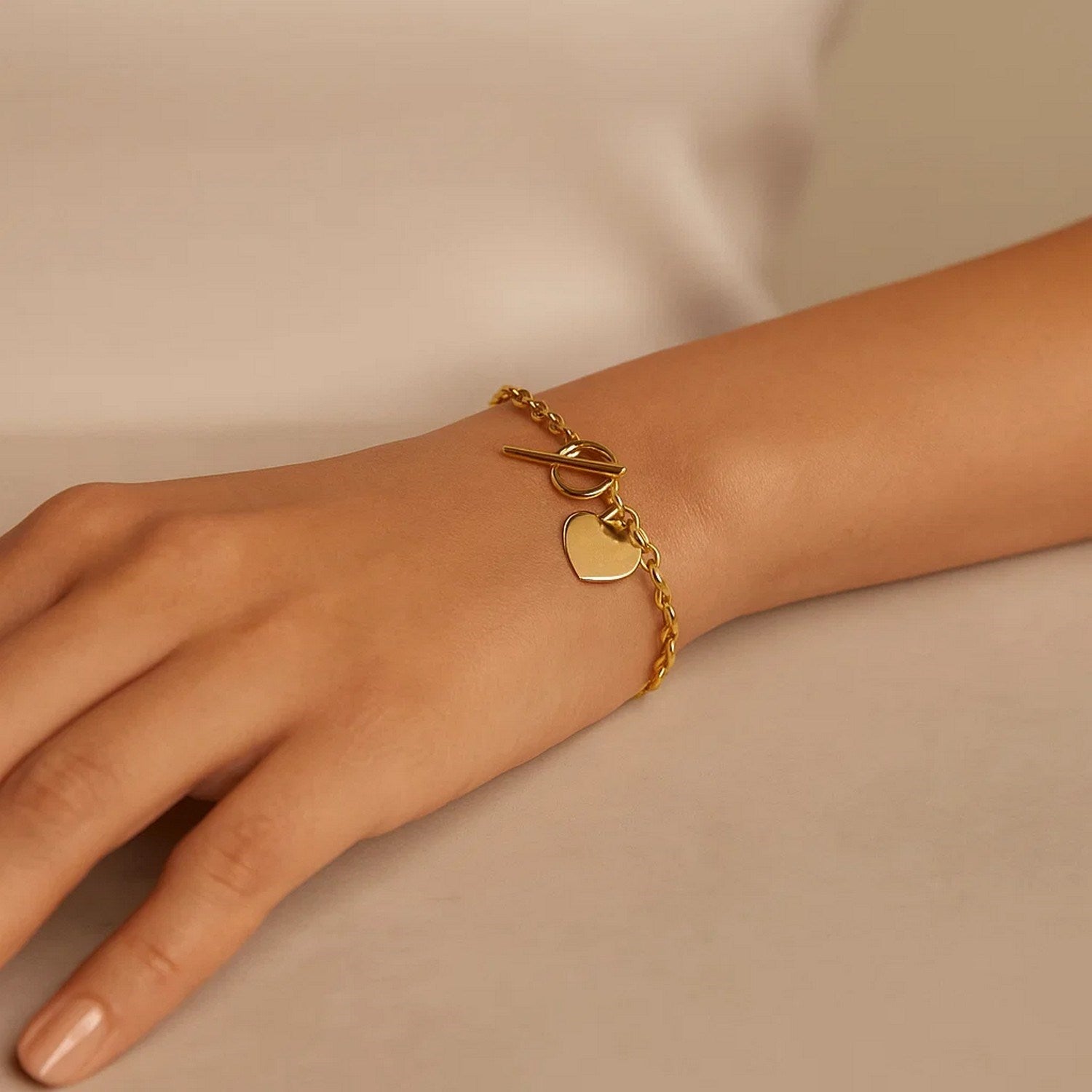 14k yellow gold toggle bracelet featuring a modern heart charm and elegant chain design, perfect for luxury styling.