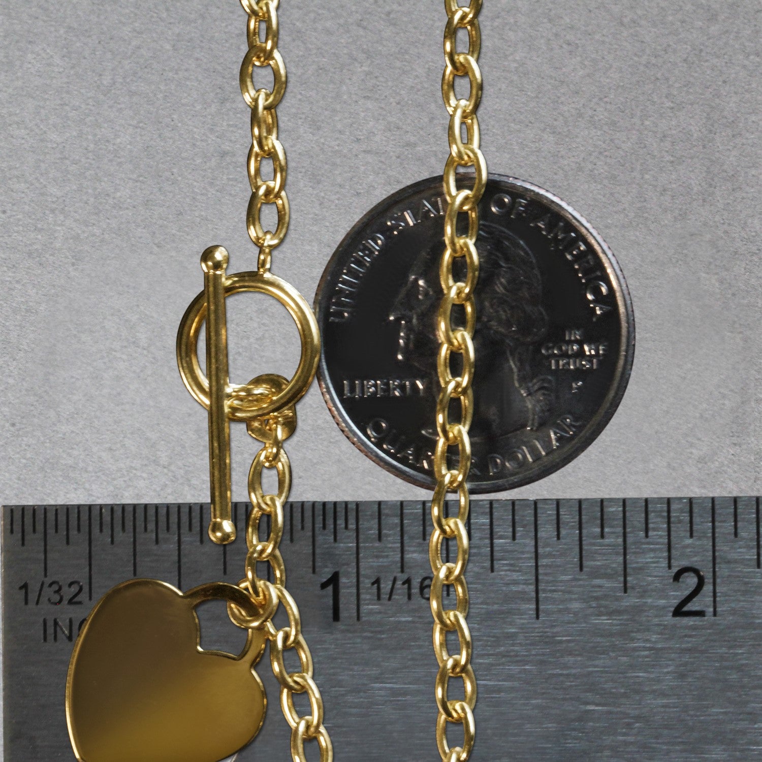 14k yellow gold toggle bracelet featuring a modern heart charm and elegant chain design, perfect for luxury styling.