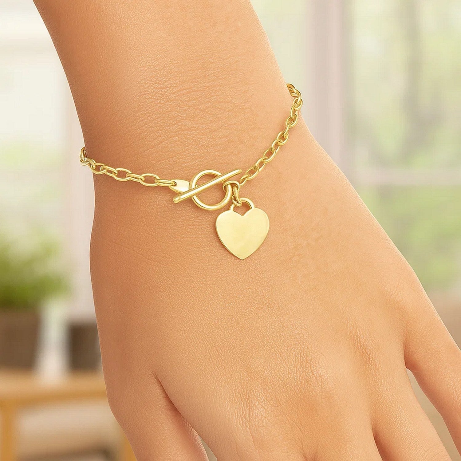 14k yellow gold toggle bracelet featuring a modern heart charm and elegant chain design, perfect for luxury accessorizing.