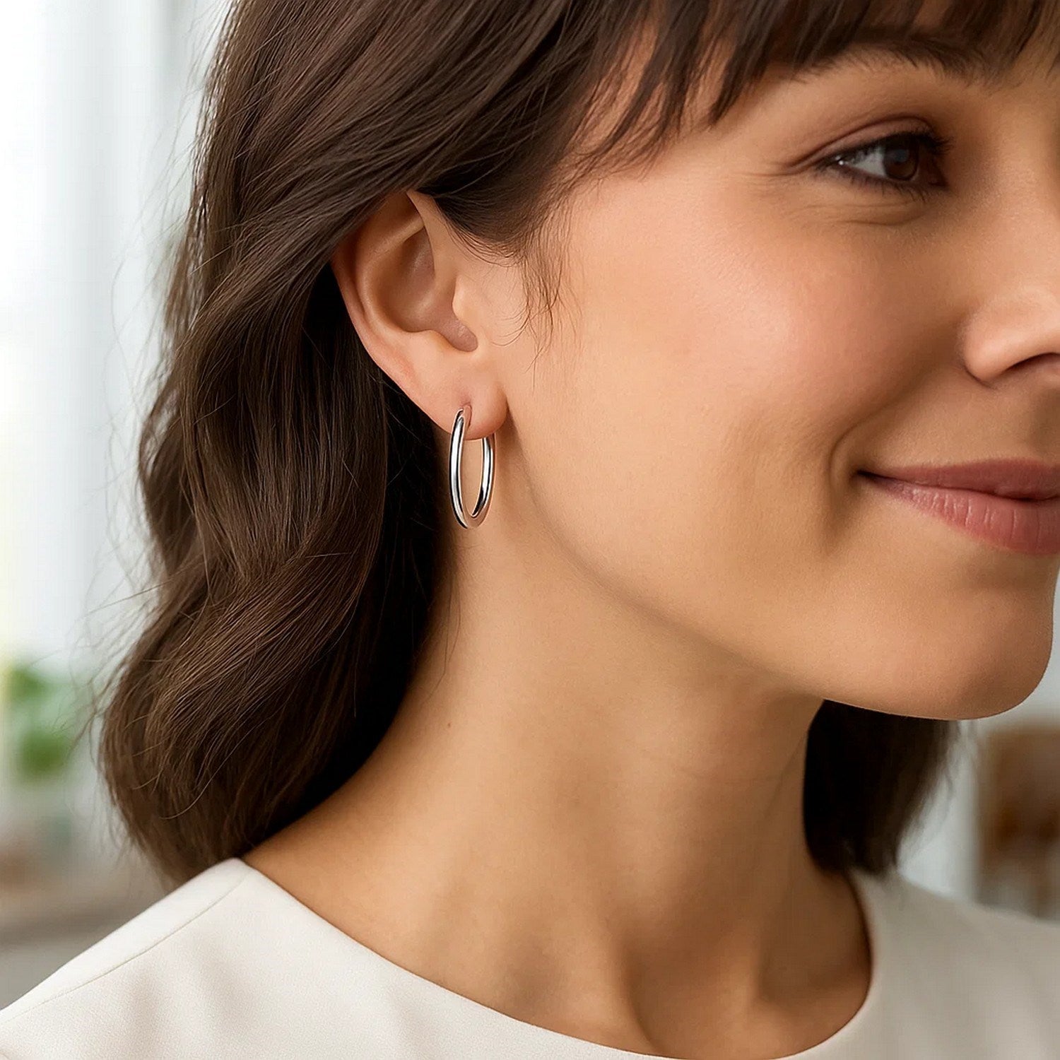 Elegant 14k white gold polished hoop earrings showcasing a sleek, timeless design for sophisticated style.